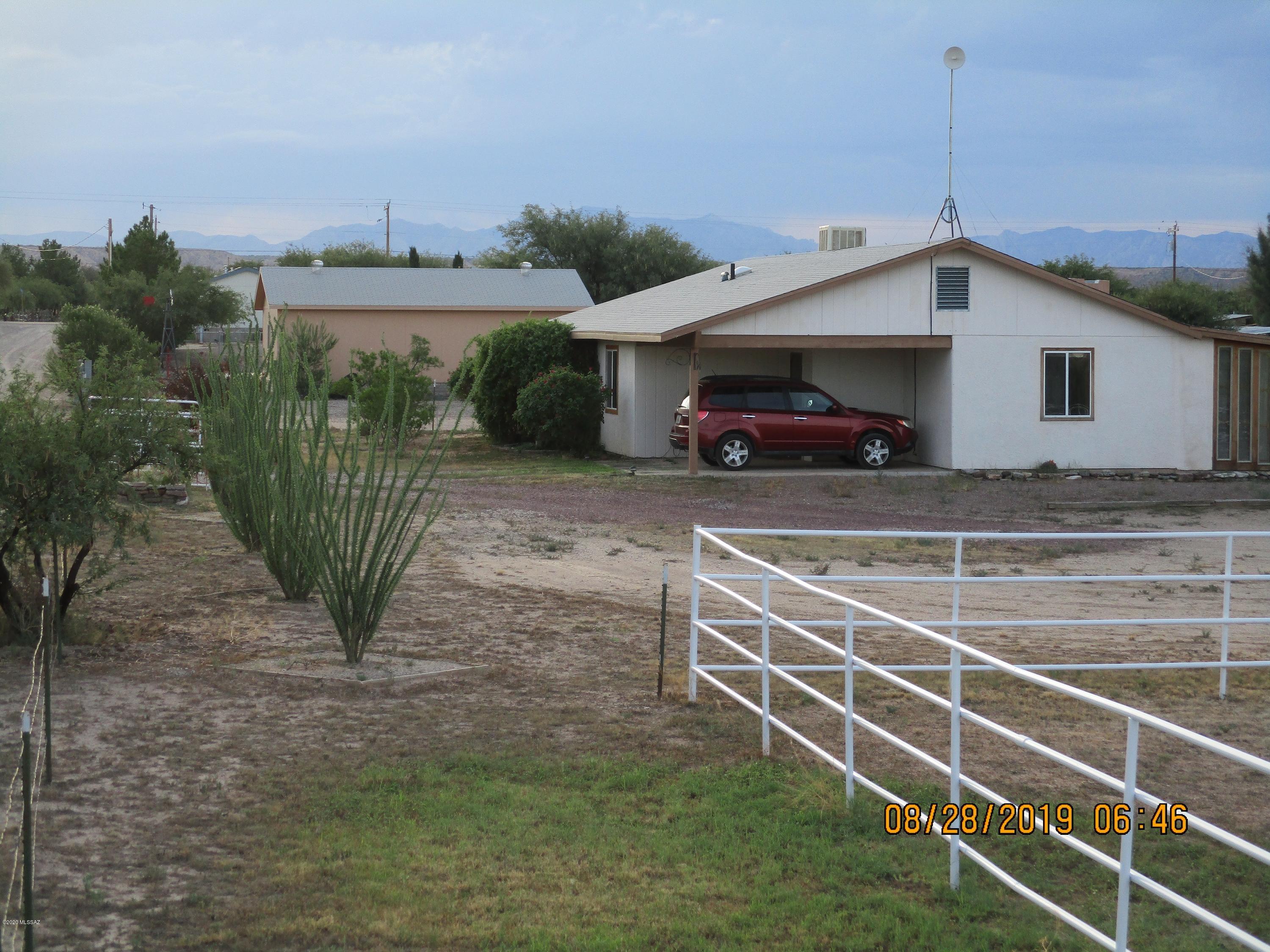 Picture perfect home nestled on an acre+ complete with a gorgeous covered courtyard + tranquil fountain.  Home is well taken care of with craftmanship throughout.  This manicured property has an enormous Tombstone Rose, roses, fruit trees and desert plantings.  Large barn for horses, big boy toys, whatever you like.  Good size workshop with water & power.  Horse arena & wash rack make this a great hobby horse set up.  Must see to appreciate!  With so much to offer, it won't last long.