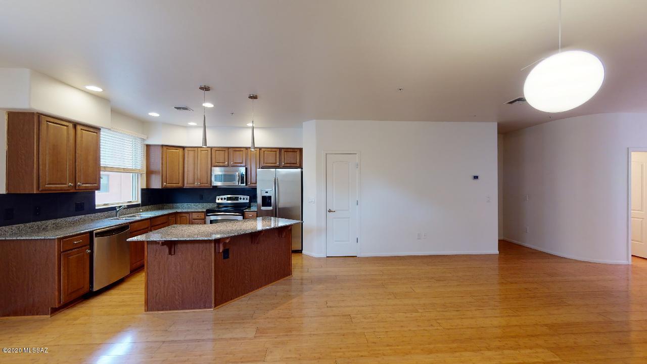 Luxury contemporary townhouse in the Catalina Foothills provides awesome views from the 4th floor 2-year-old TREX deck and wet bar. All updated lighting fixtures and stainless steel handrails and appliances add to the modern and comfortable feel of this home. This home features 2 master suites as well as a large office or gym space with additional full bathroom, and will keep you comfortable with the dual zone AC units and Honeywell wireless, programmable thermostats. Roof is less than 2 years old with transferable warranty. Great gated community features a pool, spa, gym, clubhouse, fountains, security, private walking paths and access to the Rillito River Loop. The home is in pristine condition, move-in ready for you to start living your luxury lifestyle.