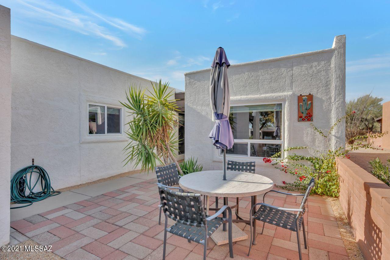 Updated and Furnished,  Lovely Ceramic tile throughout, this 2 BR, 2 BA,  updated townhome has a walled in back patio bordering common area with lovely desert views.   Located in the Villages of Green Valley with their own rec center with pool, tennis court, walking path and more.  There is no GVR, but it is available .Nice open floor plan has an office area off the the Great  room for computer, sewing or craft area.