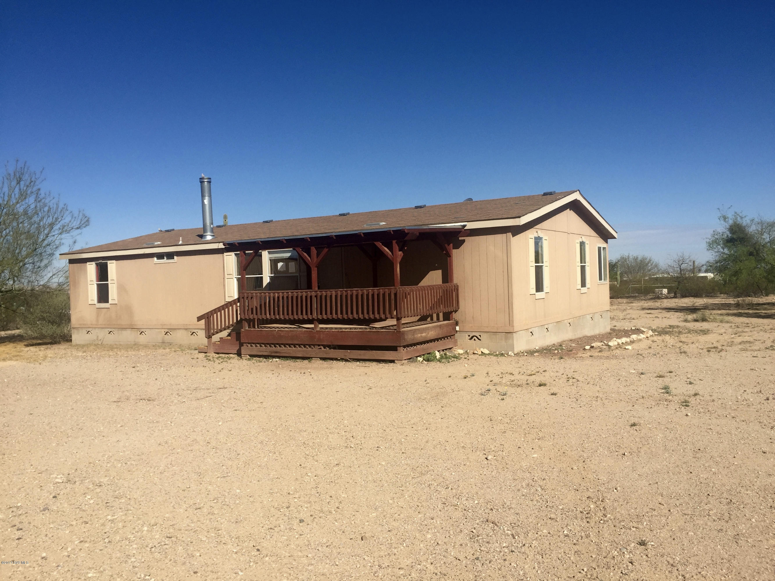 Open and private desert living with a 2004 manufactured home with 3 bedrooms and 2 bathrooms. Entire 4.14 acres fenced so you can have horses or other animals!. There is also a 25'x40' insulated steel building for a garage, workshop or ??. It has a concrete floor and a swamp cooler.