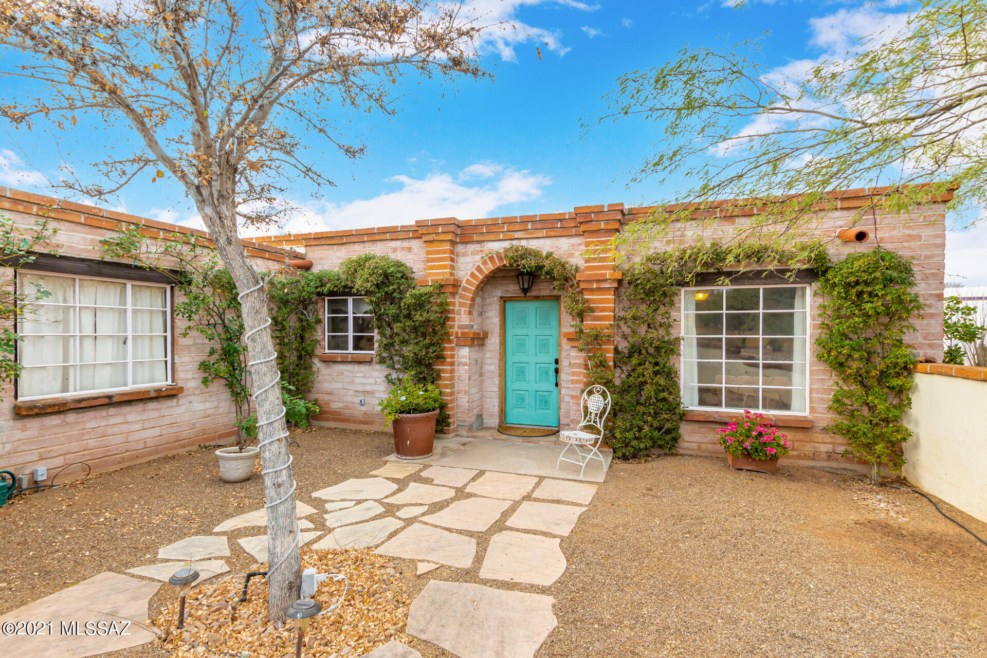 Every detail has been considered for your comfort and convenience in this spectacular home located in desirable Tubac Valley Country Club Estates. Here you'll find an elegant walled courtyard entrance with charming arched doorway plus two-car attached garage. Interior features incl spacious open-concept design with exposed beam ceilings, fireplace and tile flooring, updated fixtures and finishes. Spacious kitchen features custom cabinetry, granite countertops, stainless steel appliances, generous oversized island with seating. Owner's retreat features roomy walk-in closet plus spa-like en suite bath w/ double-sink vanity and walk-in shower plus direct courtyard access. Outdoor spaces incl covered terrace for seating, dining, and entertaining, tranquil water feature, secluded seating nooks. Extensive updates in 2011 include interior plumbing & fixtures & new septic tank&leach field. A metal insulated garage door w/controls was installed as well as  electrical breaker panel.Underground conduit replaced by utility. 95% of perimeter walls were covered with new studs & painted drywall.