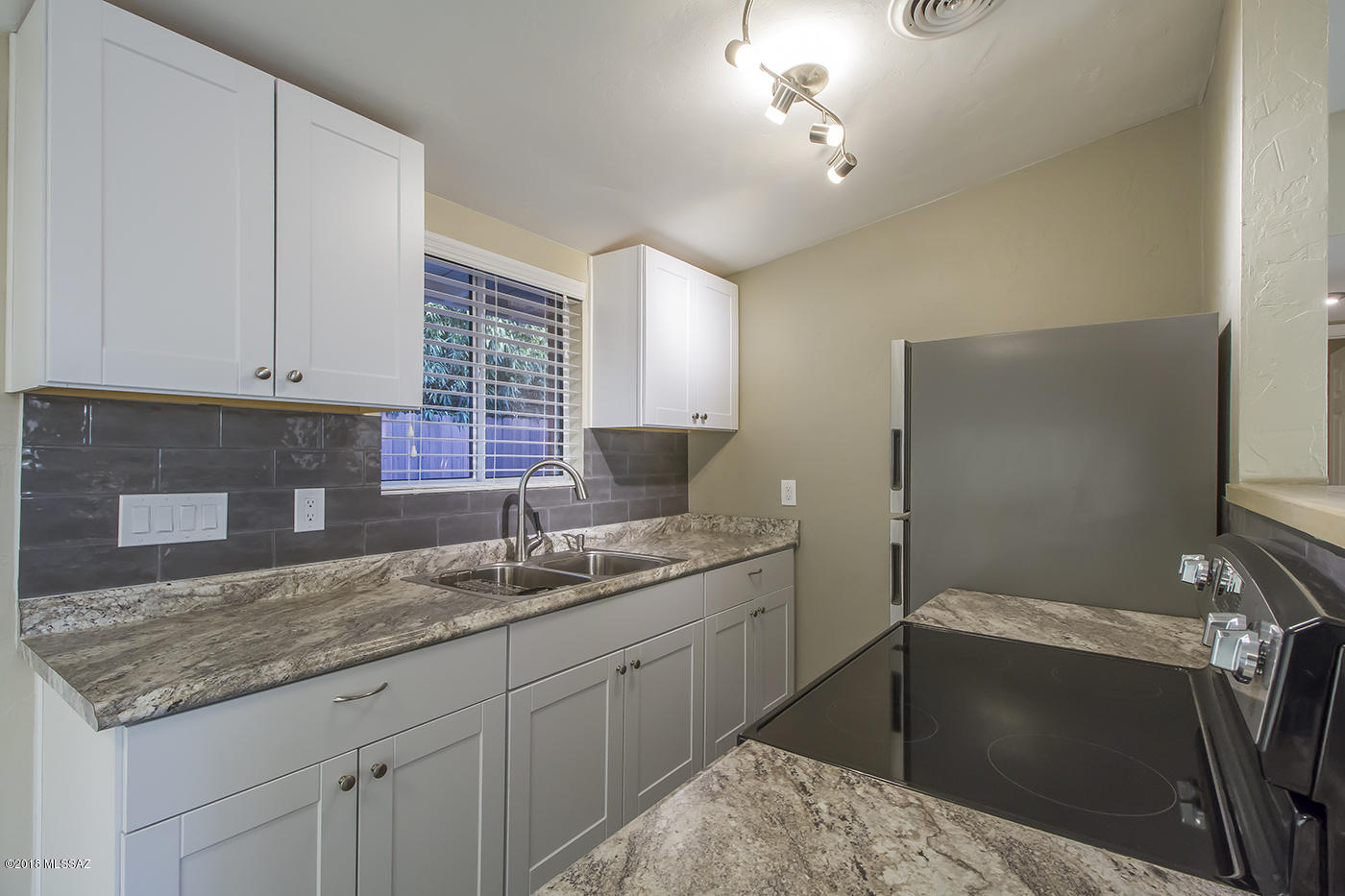 fully remodeled home, one to get excited about! This two bedroom home features new tile flooring, new windows throughout, and fully updated kitchen that open to the living area and a fully updated bathroom! The kitchen is not only updated it features a breakfast bar, perfect for morning coffee and breakfast and stainless steel appliances! Cold A/C blows throughout for the hot summer days. Enjoy the private fenced yard for entertaining. Centrally located to shopping centers and more! The resident will be responsible for a $45 bill back for the water, sewer, and trash monthly. The refrigerator and stove are included with this home. This home can be rented for 12 months or longer.