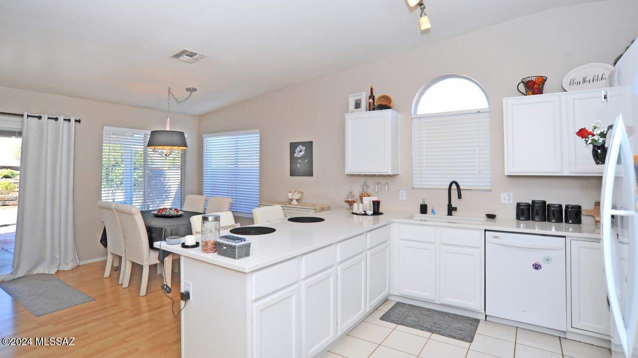 Range Price listing - seller will accept or counter offers between $320,000 and $330,000. Welcome to this sharp 3-bedroom bath home with many upgrades. The kitchen features granite counters w/ breakfast bar that opens into dining area and family room w/ slider to the covered patio. The living room features wood laminate flooring and a gas fireplace for the chilly winter nights. The primary bedroom sports French doors to the covered patio, a ceiling fan, large closets and a private bath w/ dual sinks w/ granite counters and a walk-in shower. One guest bedroom features a Murphy Bed and built-in desk area. The rear yard features tiered flower beds, brick pavers and a full-length covered patio for your entertaining enjoyment.