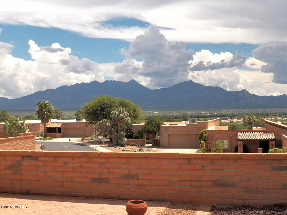 Fabulous panoramic mountain view stretching south down the Santa Cruz Valley to Tubac and beyond. Private wrap around patio. Good bones. Interior needs some updating. Roof recoated 8-2015 with warranty. Terminix termite warranty. Home warranty provided for 1 year.