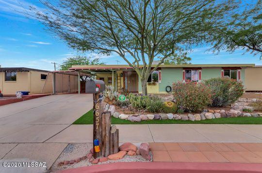 Enchanting 4 bedroom home that will steal your heart! Open & bright floor plan that has been lovingly maintained & updated. Just painted outside, super attractive curb appeal. Amazing 2 car carport plus additional concrete pad on other side of the house which is perfect for a trailer, boat or other toy. Walk through the front door & enjoy a wall of windows looking into a beautifully landscaped back yard w/artificial grass, flowers & mature plantings. Extended covered patio w/mountain views. Kitchen incl. granite counters, gas stove, SS appliances. Several solar tubes & skylights so you hardly need to turn on a light. Large master br, walk-in shower & pedestal sink. Tile floors in all rooms except 2 brs which have wood like laminate. Two water harvesting tanks, workshop+garden shed!