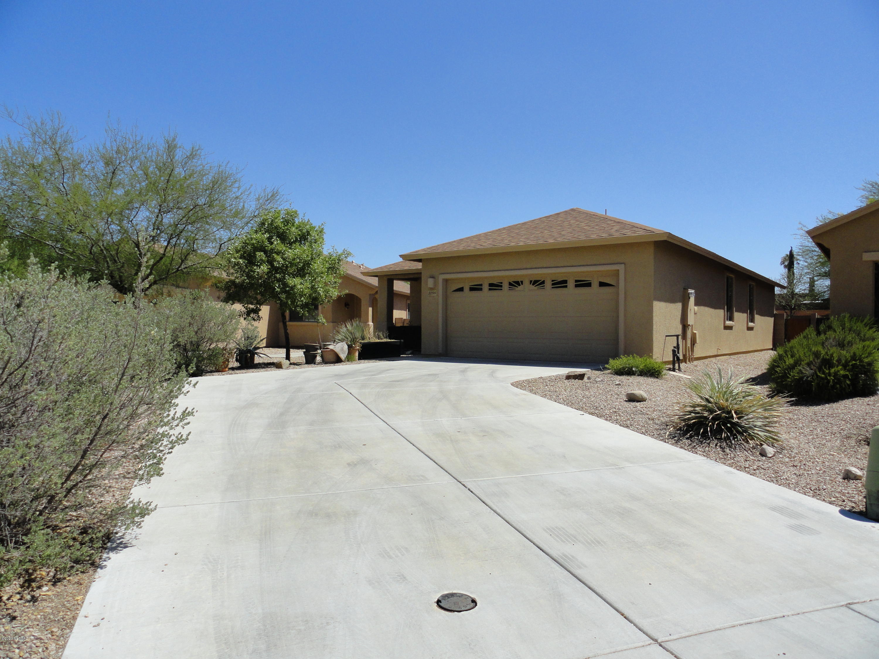 Sellers are licensed real estate agents in Arizona. Beautiful large tile thru-out this 1268 sf home with 3 bedrooms/2 baths and 2-car garage.  custom concrete overlay in bedrooms. NEW Stainless steel appliances, NEW interior paint. Great room concept. Covered patio. Long driveway provides additional parking.  Within walking distance of park/lake and elementary school.