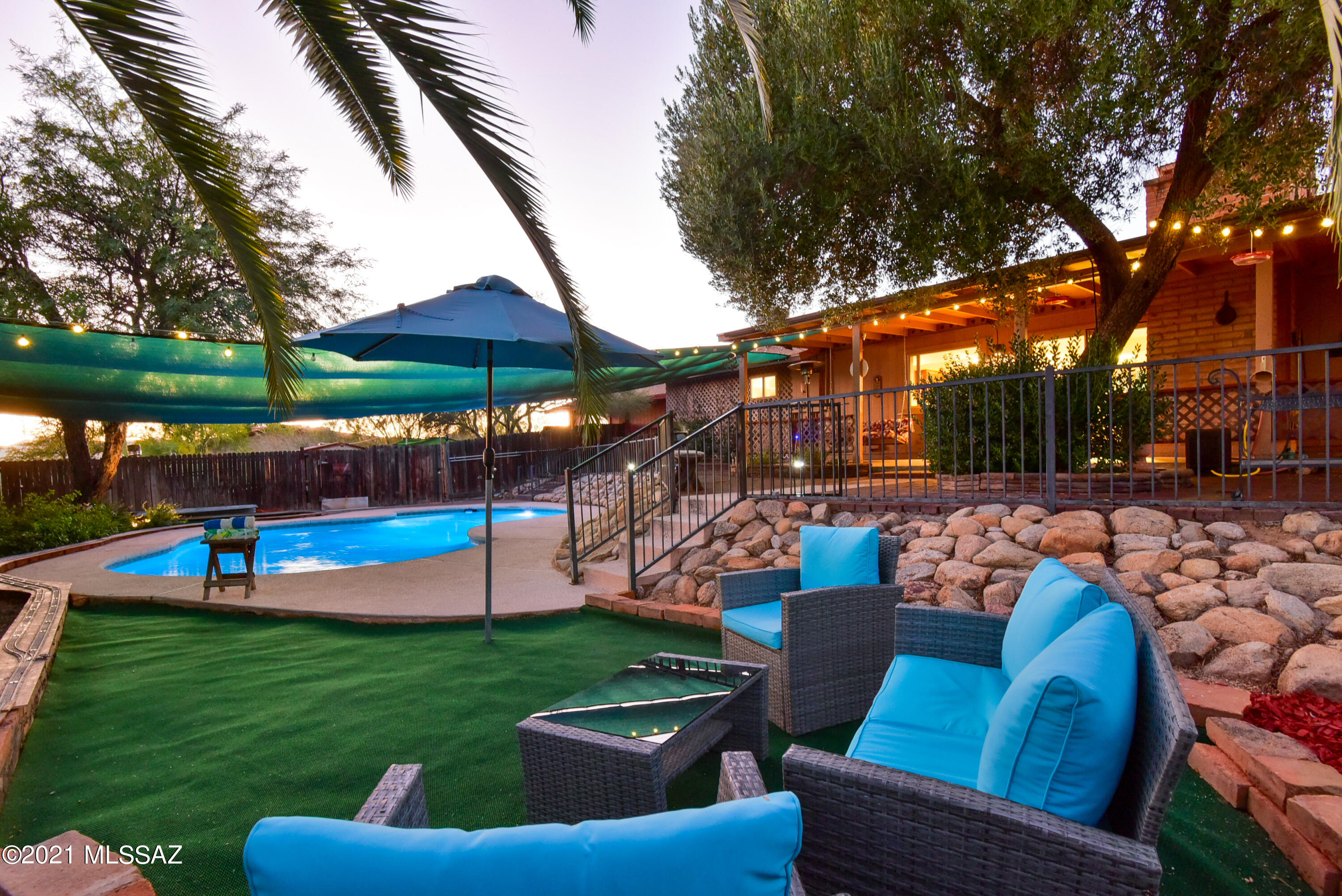 Range Pricing. Seller will accept and/or counter offers b/w $575K & $625K. Welcome home to this beautiful oasis in the desert! Sited on this 1.06-acre lot you'll find a lovely 2 bed/2bath/workshop main home (easy conversion back into 3 BR- JUST ADD BACK THE WALL); PLUS, a 500 sq ft casita (used as an Air BNB). Main house features a large workshop (can be converted to 4th bed) with a separate ventilated paint booth; perfect for hobbyist/woodworker/artist. Also featured is a cozy wood-burning fireplace, mountain views, modern kitchen, hardwood floors & natural light throughout! Private backyard haven features a sparkling pool, extended patio, multiple seating areas, custom pavers & retractable sun shades. Tons of space for all your toys, NO HOA,  privacy, & minutes from shopping & I-10! Please refer to photos to view interior of casita which is occupied by guests. 48 hour notice is required for showings of casita. (appointment must be made with listing agent to tour casita Airbnb.)