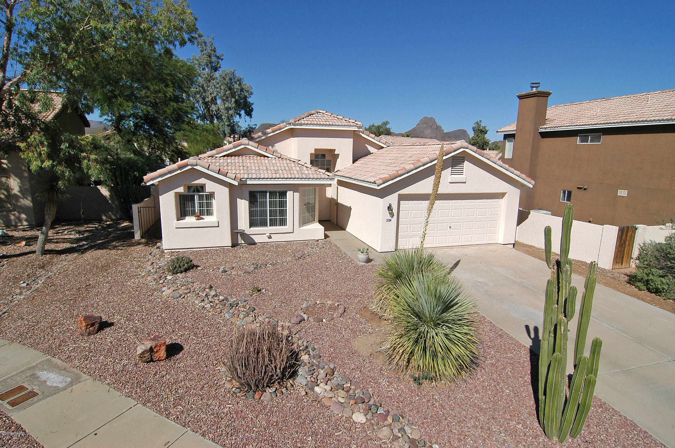 Solitude on Solitude Way is true. Great easy location in Continental Ranch. This home features a larger than normal lot, fresh painted exterior and a very clean interior with a split bedroom floor plan and a very bright family room. Tile throughout with carpet in two guest bedrooms and laminate wood floor in the master suite. The Kitchen can accommodate you and several friends if you wish to have a cooking party. Please note that Continental Ranch is one of the best price value Communities in Pima County featuring Swimming Pools, Parks, Playgrounds and many other amenities as well as a great homeowners association. You are moving into a very welcoming community. Come see us and enjoy.
