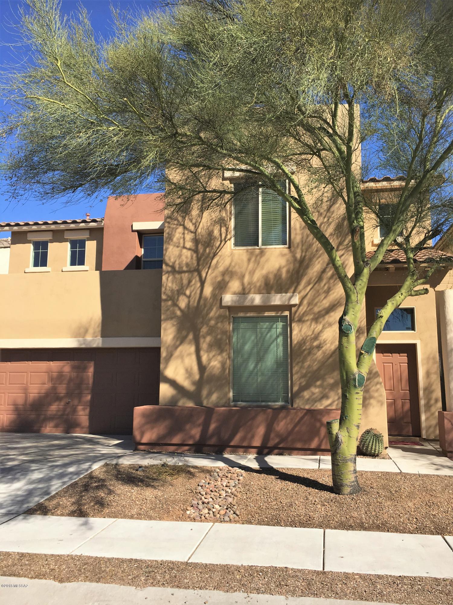 Immaculately kept home in the heart of Rancho Sahuarita. Freshly painted on the outside and a nicely kept front yard will make this home stand out. Walk through the front door and your eye is immediately drawn up to the 2 story airy entrance. The stunning new laminate floors on the stairs and throughout the upstairs in addition to the custom painting gives this home a designer look. Downstairs you have a formal living and dining room and a cozy family room off the kitchen. Upstairs you'll find 3 bedrooms plus a large master and spacious bathroom. The laundry is conveniently located upstairs and has custom shelving installed. The back yard has no immediate rear neighbors which offers nice privacy. Centrally located within walking distance to the lake and clubhouse, this home cant be missed!