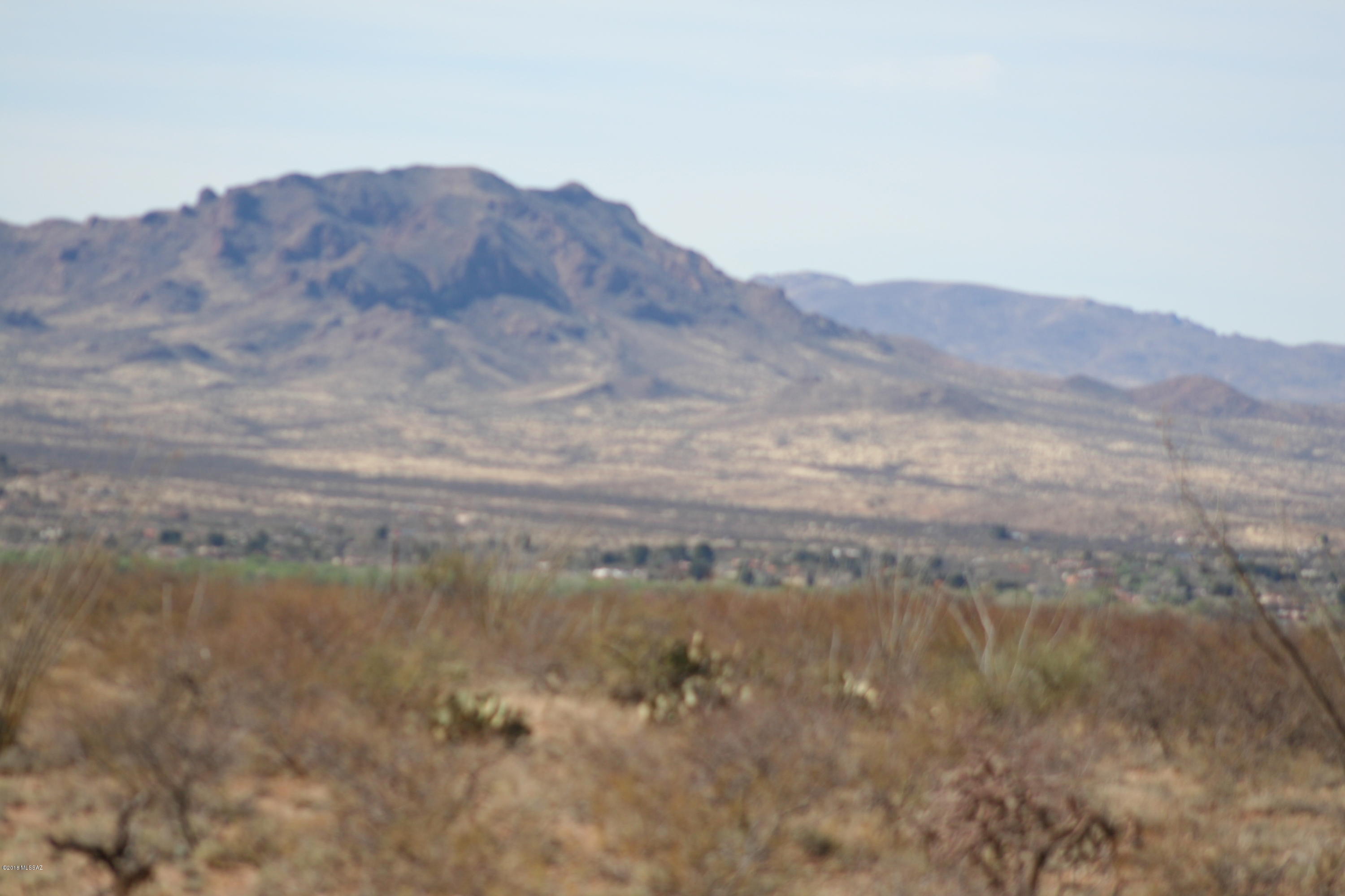 JUST REDUCED!! RIDICULOUS LOW PRICE!! This is an excellent parcel! Others priced even much higher have issues. They are steep or far from power or on a rough road...This has incredible 360 degree views including overlooking the beautiful Santa Cruz River valley and Tubac from this level, high-set building site on 14.55 acres. Underground electric is very close to easy building sites, great access. Priced to sell. Must see.