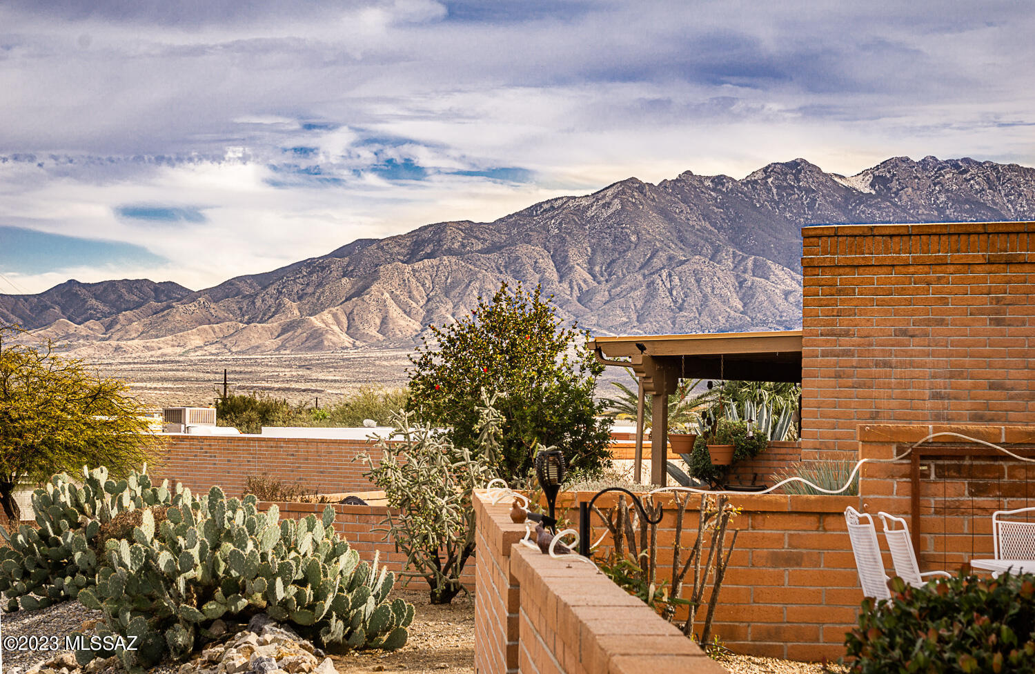 Absolutely GORGEOUS home that will check all the boxes on your wish list! So many updates in this 2 Br/2 BA + den home. Soak in the mountain views from the lovely back patio. Kitchen features beautiful granite counters, SS appliances. Rich tile throughout, fantastic updated bathrooms. Enjoy the inviting gas fireplace from the open & bright family rm.  Newer paint throughout the interior & also garage & exterior door paint. Upgraded ceiling fans. Primary BR features alcove seating area & slider to west side patio. Pretty private guest room on south side of home. Kitchen dining area opens to second east patio area that welcomes you to enjoy the variety of citrus trees. Expanded 2 car garage w/extra workshop/storage area. Pls see list of enhancements in docs. Don't miss this treasure!