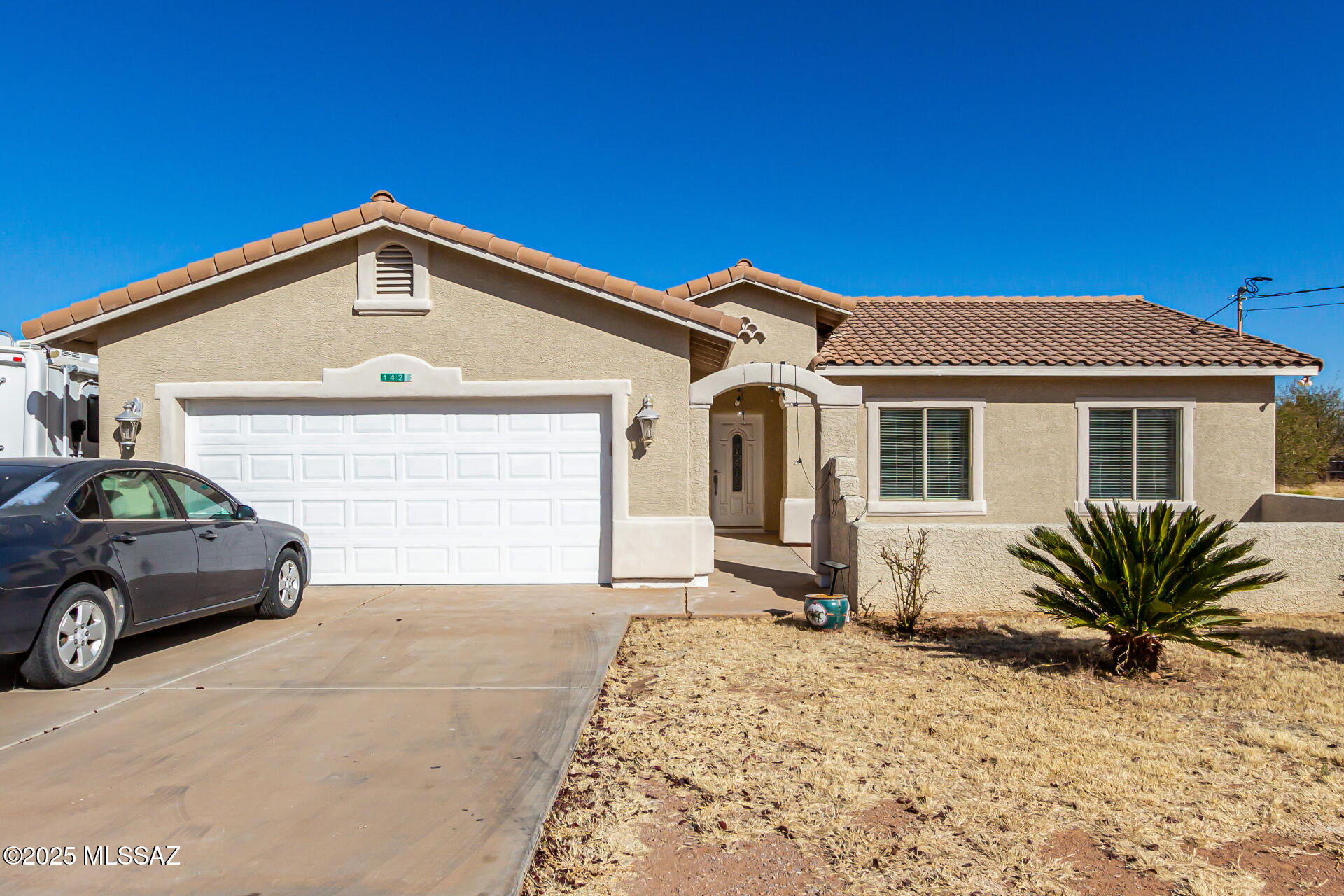 Check out this updated 3-bedroom, 2-bathroom home, featuring fresh paint and brand new tile flooring. Nestled on a spacious .44-acre lot, the property offers breathtaking mountain views. Inside, you'll find high ceilings and a large kitchen with an island—ideal for cooking and entertaining. The 2-car garage provides plenty of room for both vehicles and extra storage. With quick access to I-19 and close proximity to Rio Rico High School, this home perfectly blends comfort, style, and convenience.
