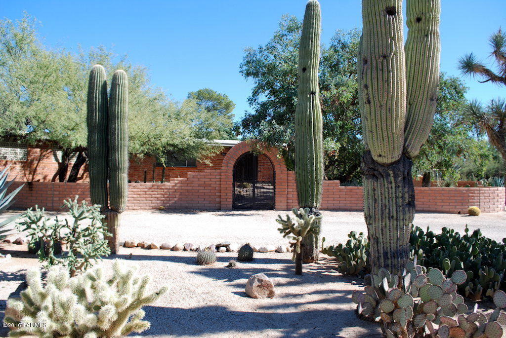 Casas Adobes 3 Bed 2 Bath Main House with 1 Bed 1 Bath Guest on .79 Acres of awesome desert landscape. 2187 total SQ FT.  Main house has custom wrought iron doors. Kitchen has lots of cabinets and counter space. Formal dining area and breakfast nook. Both baths recently updated. Ceiling fans in all bedrooms. Master bath w/custom glass block walk in shower. Guest House has wood floors, exposed brick walls and walk in closet. Private well shaded yard with lots of green landscape and kids play area. This home is offered as NON-SMOKING. Pets subject to owner approval.