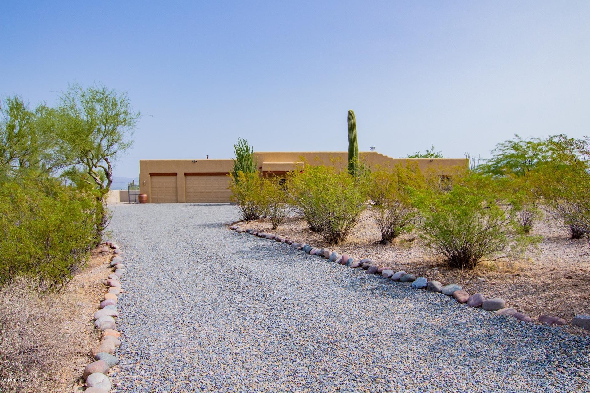 Amazing panoramic views & privacy from this 3.5 acre lot.  Stunning Santa Fe design with a true great room/dining/kitchen.  You'll enjoy the mountain/city views no matter what room you are in.  Tile floors throughout  are easy to maintain.  Very spacious bedrooms will accommodate large furniture. Car/woodworking enthusiasts take note! You can fit 6 cars in the huge garage, or use part of the space as a workshop with  220 outlets and evap cooling .  Entertain in the rear yard desert oasis.  The owner added 900 SF of patio space to the existing covered patio.  The sparkling pool with a waterfall is separately fenced for safety. There is even a gas hook up for your grilling pleasure!  Water softener & Spa stay as is! Listing goes live Saturday 9/24/20.  OH from 11-2PM.