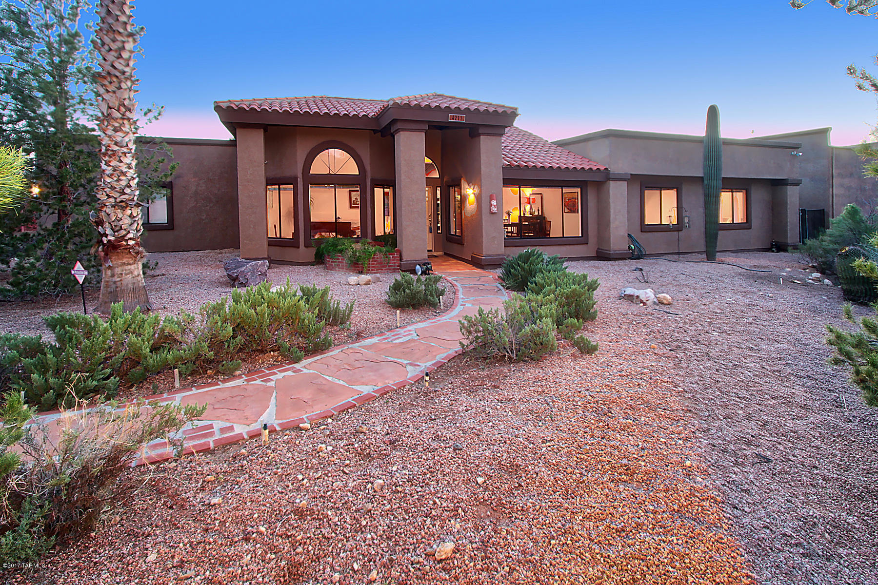 Live the dream in the 4 Bedroom 2 bathroom house with private gate, an oasis back yard that has a pool with waterfall, shady entertaining areas, private walk to sunset/deck with sitting area. This home is complete with 2-car garage PLUS separate workshop which could hold 4 cars or RV. Kitchen with stainless appliances, quartz counter tops, opening up to vast great room. 2 fireplaces, soaring ceilings, and no carpet! Loads of storage, and space to entertain many guests. Views of Catalinas, and Sunsets.  Don't miss the creek view, and the twinkling lights under the shady covered back porch. Private Grotto off the master bedroom has hot tub with Catalina Mountain Views. Master Ensuite has jacuzzi tub, dual vanities, custom tiled shower, and enormous walk-in closet. Fireplace in Master bedroom