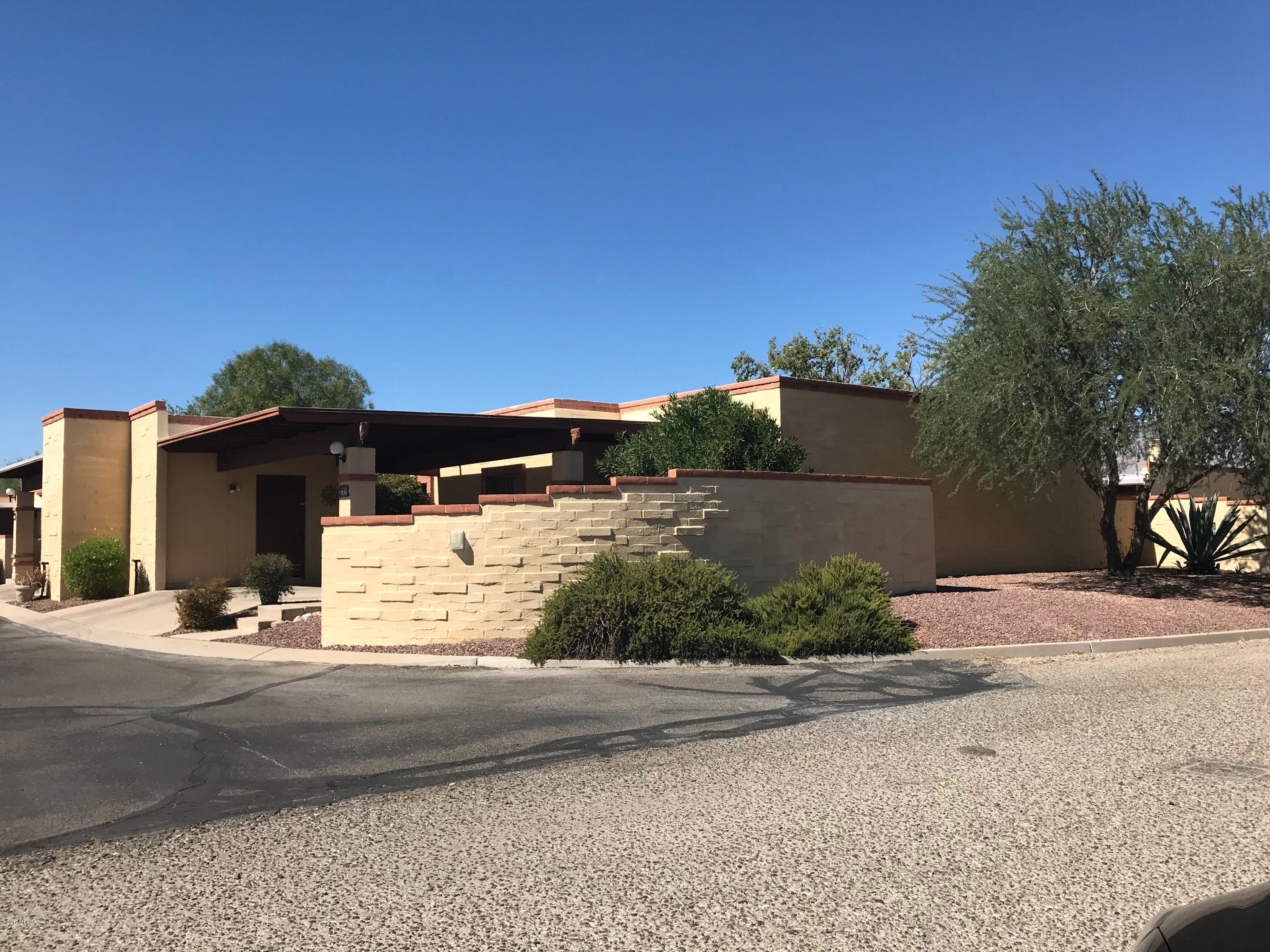 Private Corner Town house with a view of the Catalinas in the NE community in the peaceful Woodland Villas. 2BR/ 2BA with a DEN! and a Fireplace! Very Large community pool with picnic area. HOA includes front yard maintenance, exterior pest, Fire Protection, pool and trash. New water heater, newer HVAC, Well Maintained home.