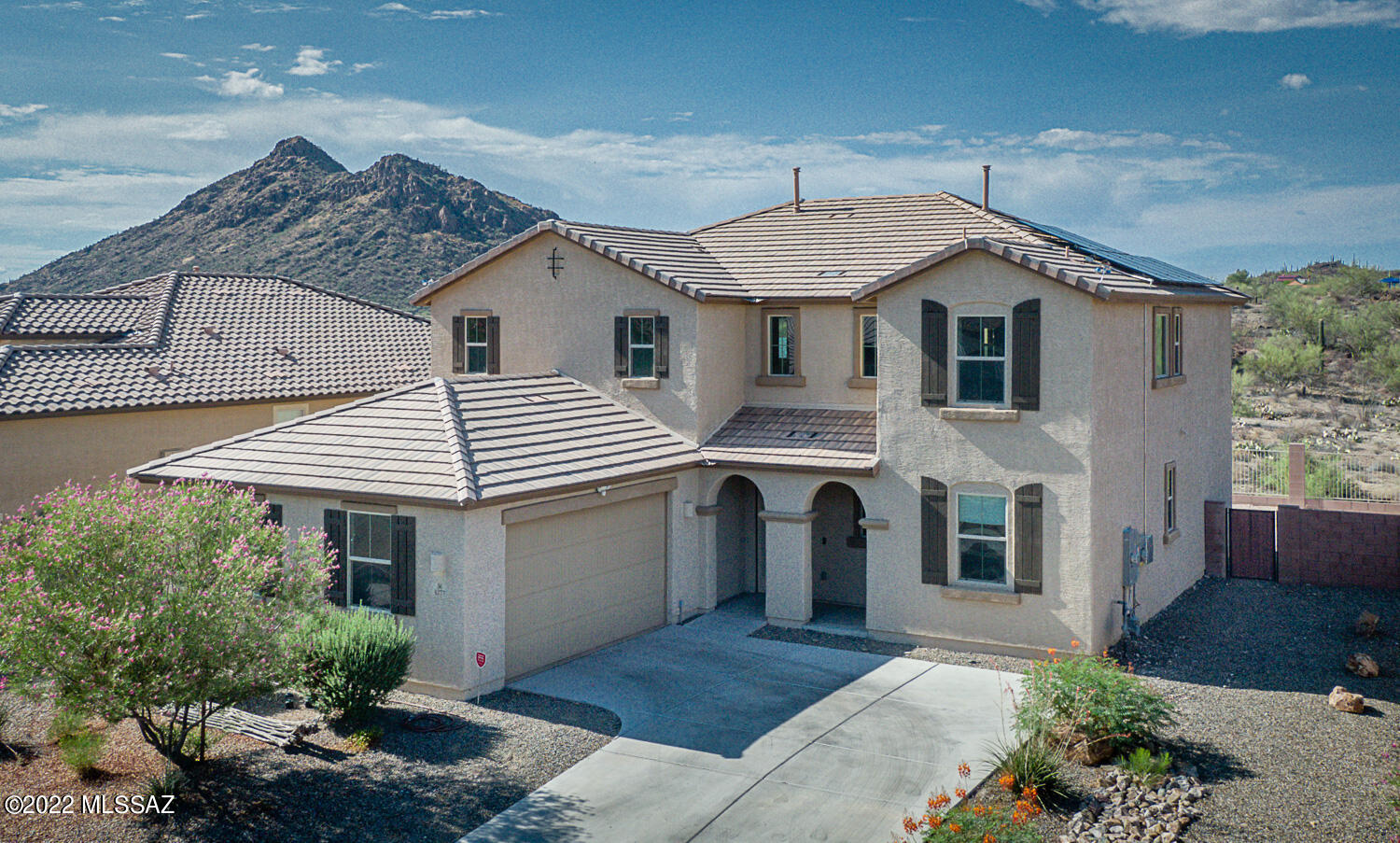 ****SELLER WILL CONSIDER ALL REASONABLE OFFERS. ****WORRIED ABOUT INTEREST RATES?  Check out the ''Two One Buy Down'' that offers a 2% interest rate reduction the first 12 months & 1% the second 12 months through Jerry Sundt/Crosscountry mortgage, at:  520-370-9576. 
Surrounded by both Cat and SilverBack Mountains, this is a great house for entertaining!  A welcoming foyer leads to the home of your dreams.  Moving inward on the right is a bedroom and full bath to complete the first floor en-suite.  This home is equipped with a seller owned 12.6 Kwh solar system! There's a huge kitchen with pull out cabinets galore; an oversized 9' granite island, a walk-in Butler's pantry leading to a formal dining room and an enormous Great room! This home is made for your special events with the double ovens and 5 burner gas top which makes holiday cooking a breeze. The home features include a Central VAC system, wired for ceiling fans,  ample electrical outlets throughout the home, and extensive shelving in all closets. There is a R/O in the kitchen sink, new porcelain tile in the Great Room and dining room, security doors front and back, and a wired/installed security system on main floor windows and doors.  The garage has an epoxied floor, a mini-split HVAC, two overhead racks for your additional storage.  The 50 gal gas hot water heater and the water softener are tucked into nooks so all vehicles have better access.  Upstairs has a large loft which can be accessed by stairs or the Acorn Stairlift. The upstairs also features the master en-suite, large walk-in closet, bathroom with double sink vanity, separate soaking tub and shower, 2 additional bedrooms, a full bathroom and a Large laundry with plenty of cabinets, shelving and a sink. Views abound everywhere. The patio opens to a large backyard and a common area.