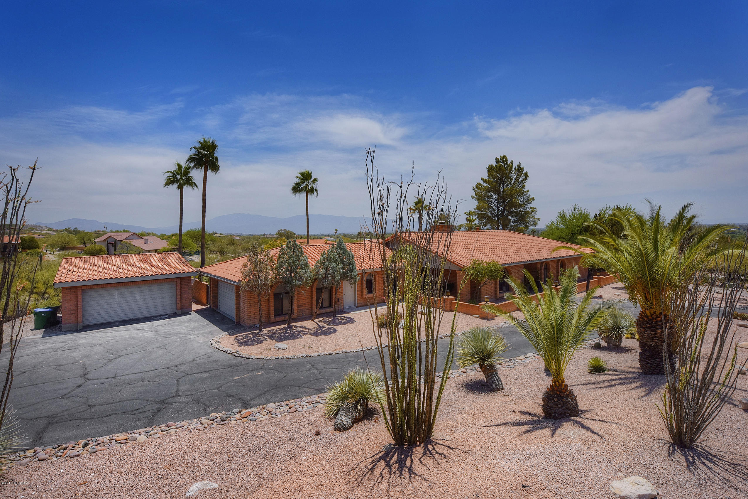 Welcome to the desirable River Hills Estates. This newly upgraded modern Ranch home offers it all. With over an acre lot, you have four car garage space, large circular drive and plenty of room for RV, trailer or toys. The low maintenance front yard still pops with light accents of desert plants and flowers. The new slate entrance invites you in to enjoy 3400 square feet of comfortable luxury. A huge great room is waiting for you to enjoy a drink by the fireplace with friends or family. Around the corner you can enjoy the mountain views from a beautifully updated kitchen, dining room, or the cozy sitting room. Rough edge granite, clean lined custom cabinets and stainless steel captivate you while preparing a meal in the remodeled kitchen. When you are ready, the elegantly remodeled master bath is the place to find quiet relaxation. Marble floors lead you to either the large garden soaking tub, or the glass surrounded rain shower. After a good night sleep in the grand master suit, head out to the back-yard living space. Here you can enjoy a coffee on the covered patio, or take a swim in the large sparkling pool. Nestled in the Catalina foothills, mountain and city views draw your eyes across the large grass landscape. Start your work day from home in the large private office, or get a workout in the gym-room off of the patio. The additional three large bedrooms offer plenty of space for the kids or guests. If exploring is your thing, you are walking distance from, desert trails, the Tucson river walk, shopping and fine dining. If golfing or country clubs suit you better, you are a ten-minute drive from the Luxurious Loews Ventana Canyon Resort and golf club.