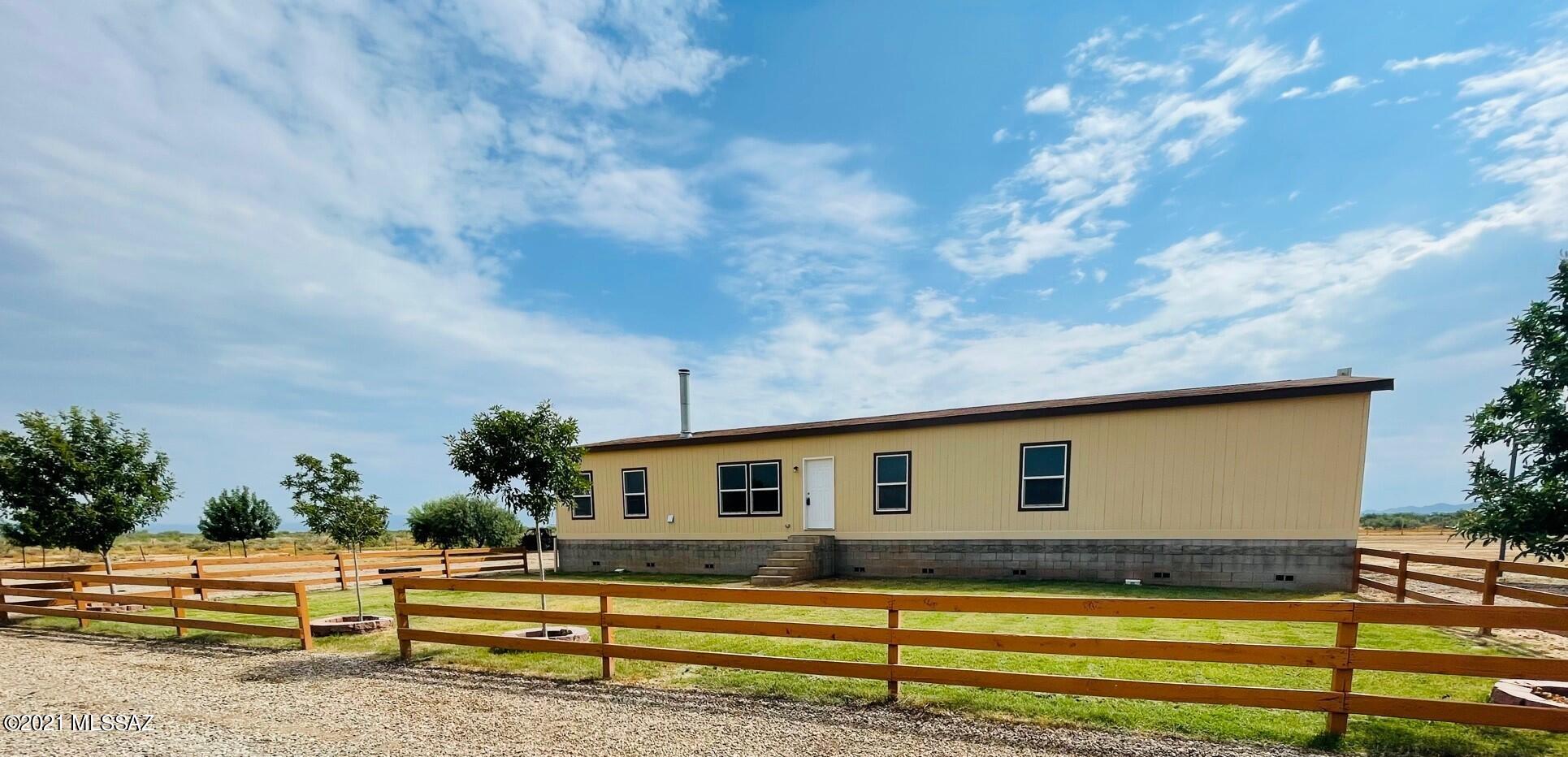 5 Acres Horse Property with Private Well -Beautiful open floor plan welcomes  families  to enjoy serenity and gorgeous sunsets.  Walk into an open great  room, stone fireplace  and large kitchen for entertaining. Four bedroom  house with a  large living room and an additional TV/Game  room. Large master bedroom with  a walk through closet  and relaxing Jacuzzi  rub.  This house bas two separate backyards, all surrounded by a  5' chain-link  fence. Enjoy the sunrise on the raised backyard deck. Insulated  windows, 2x6 construction, R-50 roof insulation.  Nine-foot ceilings throughout make this home feel light and spacious. PRIVATE WELL COMING SOON. Come and see your new home!