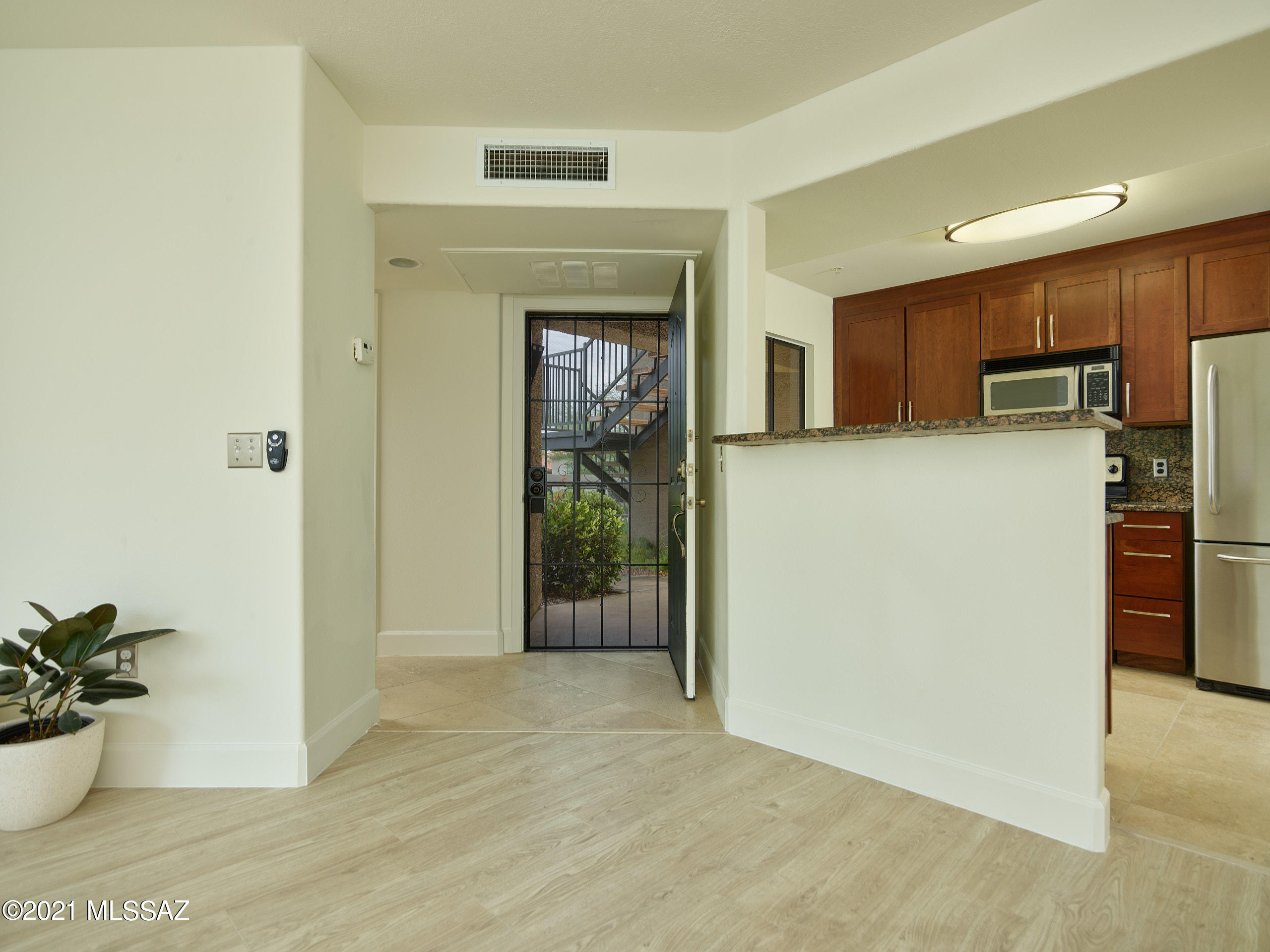 Completely upgraded 2 bedroom corner unit backing to common area with majestic views of the Catalina Mountains. Features include cherry cabinets w/ granite slab counter in kitchen and baths, Stainless steel appliances, tiled shower surround in master bath, freshly painted, new Pergo flooring,  modern baseboards plus a security screen door at the front entry. Additionally condo had a brand new AC system installed in 2020. 24 hour gated access, 2 resort style pools, 24 hour state of the art fitness center, mature landscaping and CLOSE to restaurants, shopping, hiking, biking  and much more! Ready for immediate move in