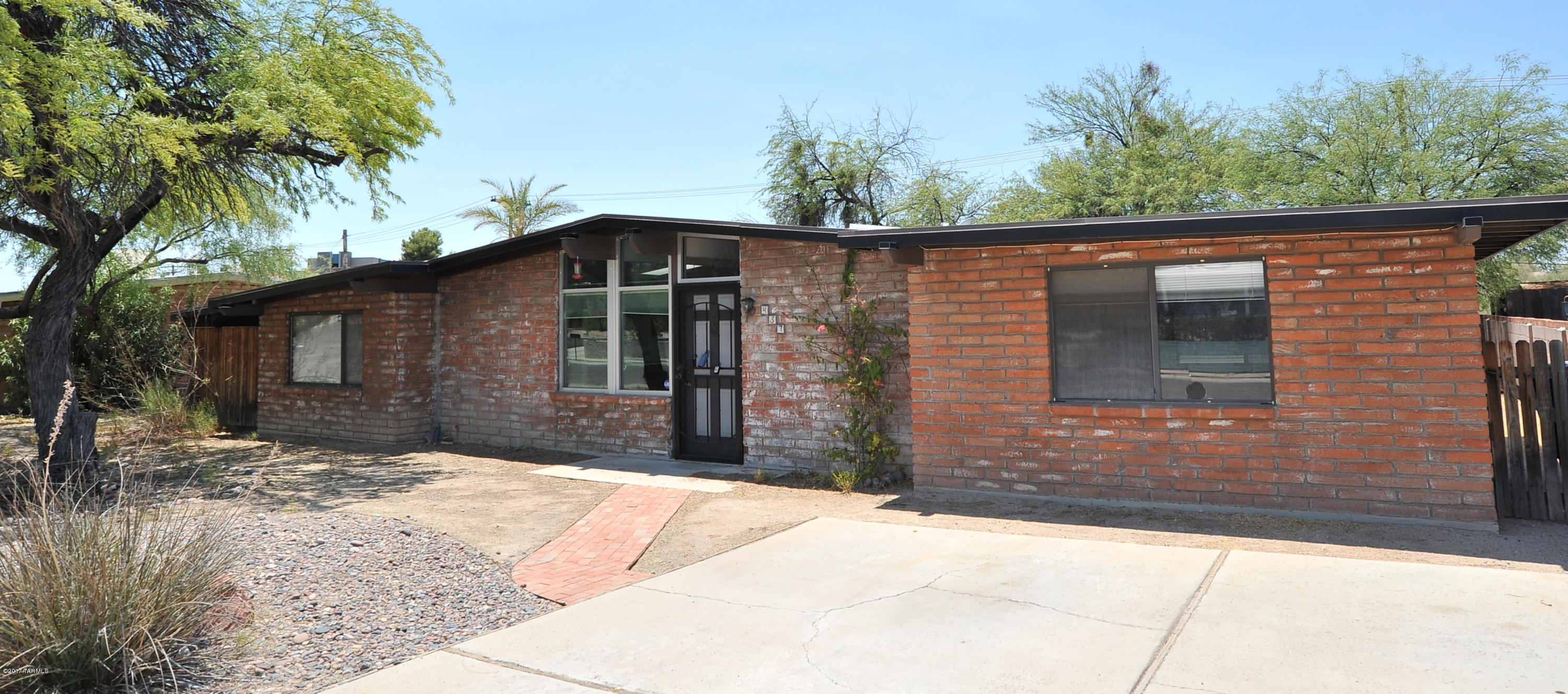 Charming one story, three bedroom and two bath,  1641 Sq Ft burnt adobe ranch home in desirable El Gheko Neighborhood. Value priced at just $91.34 per Sq Ft, affordable for 1st time home buyers and investors (rental income) alike. Features and updates include: new 16 SEER gas pack/furnace AC/Rheem condenser with 10 year transferable warranty (3/2017), double pane windows, gas stove, sky lights, ceiling fans, interior laundry room, cast iron tub and vintage tile in bathroom, tile/laminate/carpet flooring,desirable exposed burnt adobe inside, covered patio, private backyard, sitting on a large .18 acre lot that backs up to private wash.  No HOA and space for RV parking.  Walking distance to St. Joseph's Hospital, shopping, and restaurants. Gas line replaced 2016. Fantastic east side location off Broadway.   Ideal for those working at Davis-Monthan Air Force Base, St Joseph's Hospital, Tucson Medical Center, or the Park Mall.  Dare to compare, come view for yourself today.