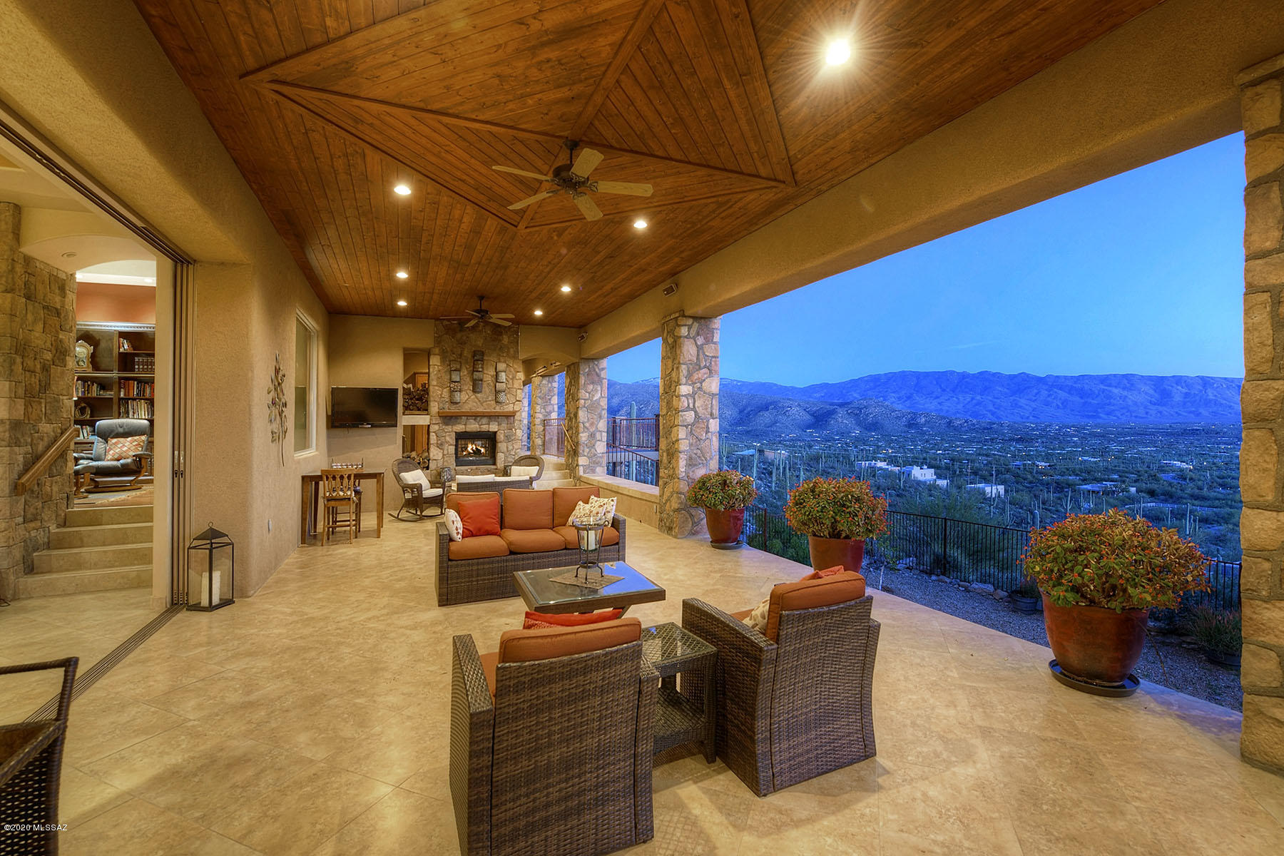 Amazing Panoramic Views atop this hillside lot! Lush front courtyard w/ rock waterfall greets you. Built with custom fabricated SIPS panels for a stronger, greener home. Generous great room w/ dual fireplace, travertine flooring & disappearing doors that open up to outside. Kitchen features double islands, 3 dishwashers, warming drawer & high end stainless appliances. Master suite offers luxurious bath, 3 way fireplace, soaking tub & huge walk-in closet. Also has private patio with outdoor wall bed so you can sleep outside on those warm nights! Workout room includes steam shower. Extended back porch with wood plank ceiling, outdoor kitchen & VIEWS!! Guests will enjoy their own house with living, kitchen & br/ba. Large heated/cooled workshop off garage. Owned Solar, a spectacular place!