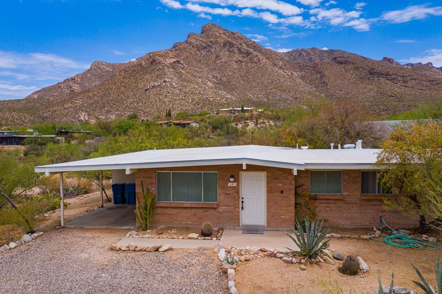 Fantastic northwest living opportunity! Ranch style home nestled on a large lot with spectacular Catalina Mountain views. Surrounded by lush natural desert vegetation. Home boasts 4 bedrooms! Bright kitchen with sliding glass door to back patio for that morning cup of coffee!  Freshly painted inside with new carpet in bedrooms. Separate enclosed laundry room. Plenty of exterior storage. Don't miss this opportunity to live in the desirable community of Rancho Catalina. Close to shopping, eating establishments and outdoor recreational activities. Come see today!