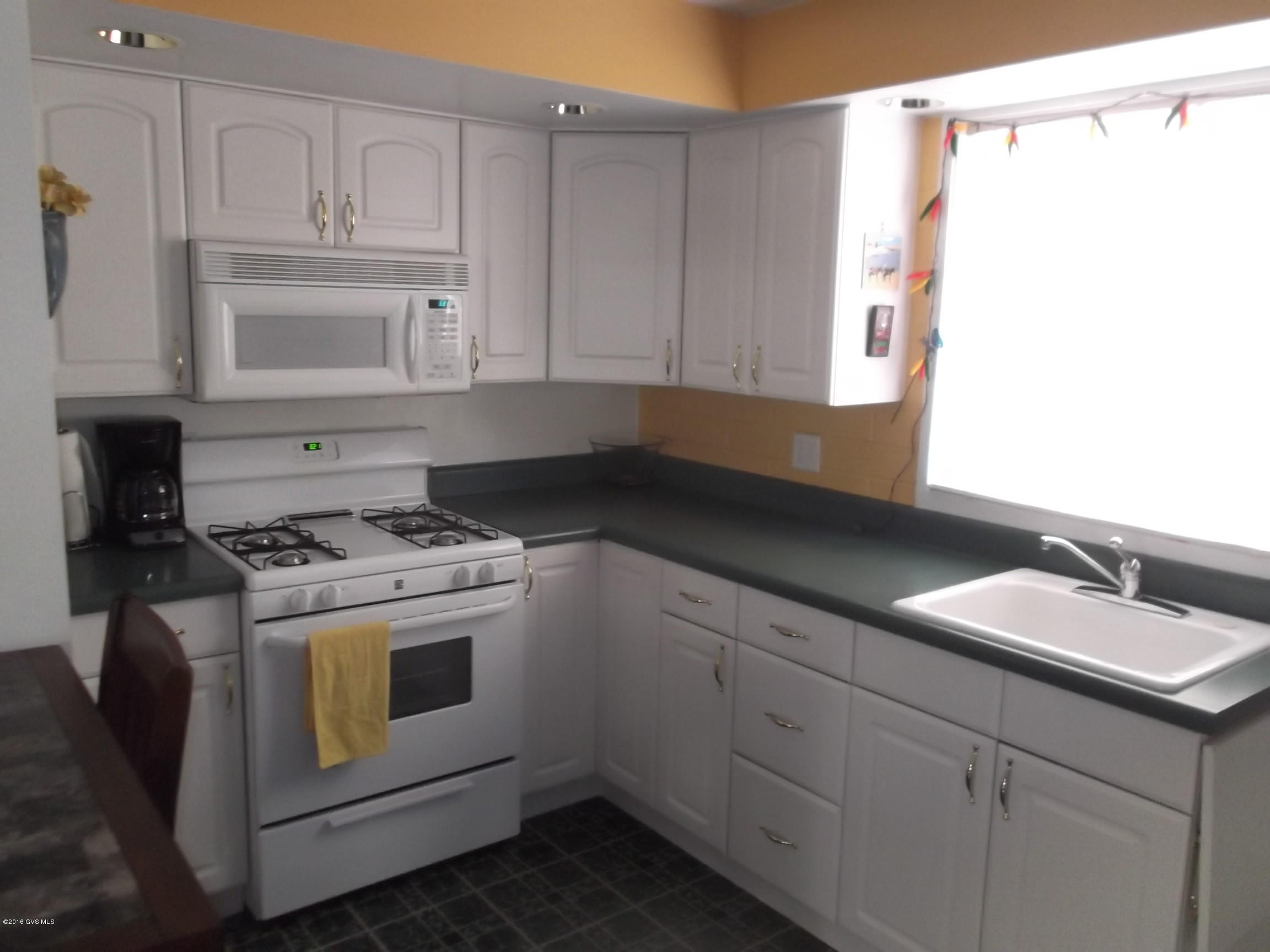 This unit is unique and welcoming. For a small unit it has exceptional storage, and shelves in the main living room for TV, books, CD's and favorite treasures. The bedrm has a built in desk, and shelves and lights over the space for the bed. The closet has built in shelves. It is located across the street from the pool, and the laundry is next door. HOA takes care of the building, roof, heating/ac equipment. hot wtr tank, grounds, pools, streets. This makes for easy living, and a great get away or full time home. COME and SEE while it is available