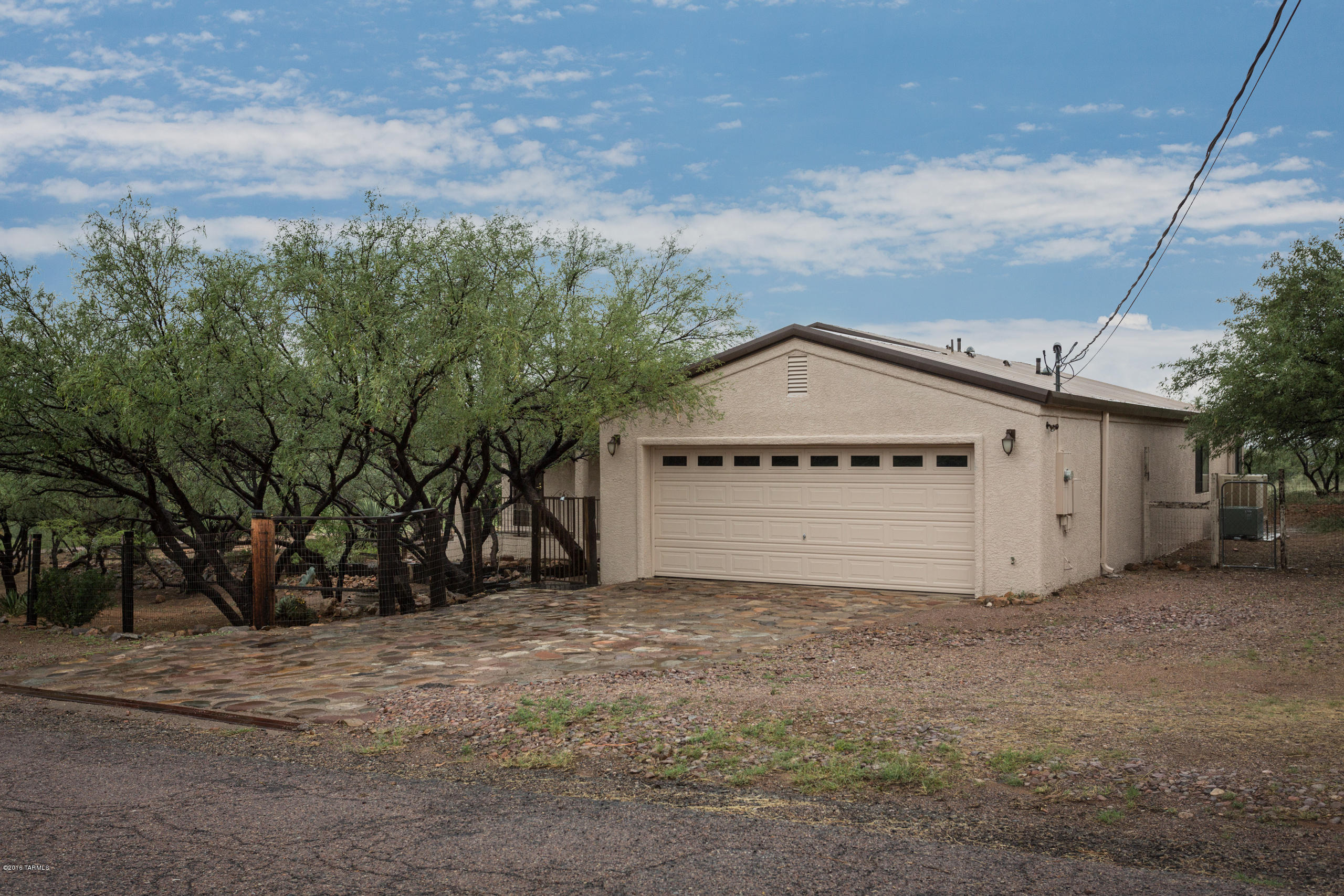 Immaculate home situated on huge corner lot in coveted Rio Rico Ranchettes 4 Subdivision! Property features metal roof, new interior/exterior paint, a large two car garage, laundry room, stone/concrete driveway, covered patio with slate flooring, mono block plumbing system, heated/cooled Arizona room, premier wood cabinets, new carpets, laundry room, fully functional evaporative cooling and air conditioning units, large walk in closets, and brand new appliances! Enclosed back yard includes established vegetation, swing set, and fountain! This home will not last!