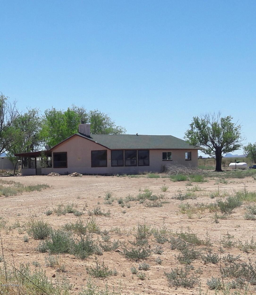 Spacious two bedroom home with huge living room, formal dining room, large Arizona room, two car garage, and room for the horses!  This property has been remodeled: New septic, new pressure tank, new heating system, new flooring, kitchen appliances and washer/dryer, new bathroom fixtures and more! Nearly five acres with awesome views of Cochise Stronghold and the Chiricahua's. Has a round pen for the horses and plenty of room to add more horse facilities.
