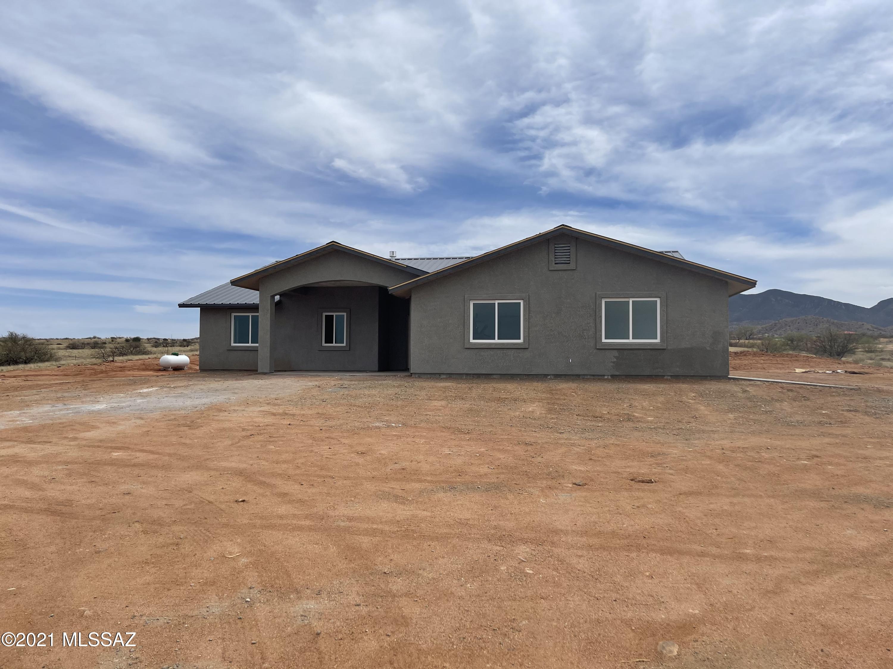 This Ranch Style 4 bedroom 3 bath 2245 sqft semi-custom home sits on a 4 acres lot with AMAZING panoramic views.  The home includes an open floor plan concept with two master suites, 2 car garage and covered patio.  Some of the features include granite counter tops throughout, wood laminate flooring, hexagon tile in bathrooms and laundry room, garden tub and walk-in shower, fireplace, metal roof, split floor plan and more!  Looking for NEW CONSTRUCTION?  Call today to discuss the possibilities!