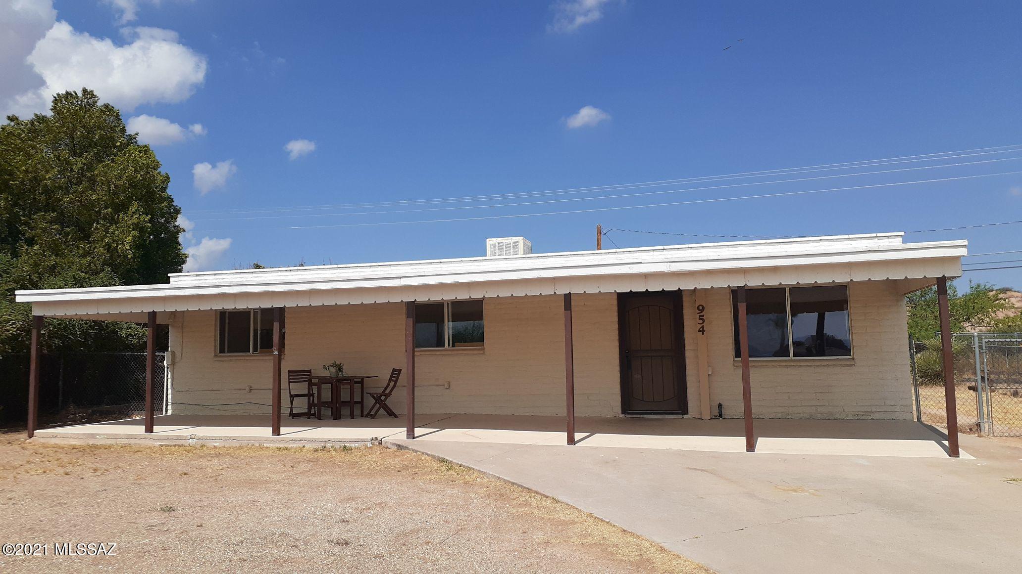 This is a solid-construction, concrete block, site-built home in an established neighborhood, conveniently located just minutes to all the amenities of Benson.  This tidy 3-bedroom, 2-bathroom home has been diligently maintained & is move-in ready.  With a fully fenced, large front & back yard, & a huge shaded front patio (east) & back patio (west), this place is perfect for people with kids or pets! Climate controlled by central evaporative cooling & ceiling fans in every bedroom plus the kitchen, & central natural gas heating for the winter. This home also boasts a laundry room/pantry & mud room entry from the back yard. Mountains are visible from the front living room & patio. The back yard borders on open space & also has a nice desert mountain view. Home warranty included! Just add your personal style & make this place your own!
