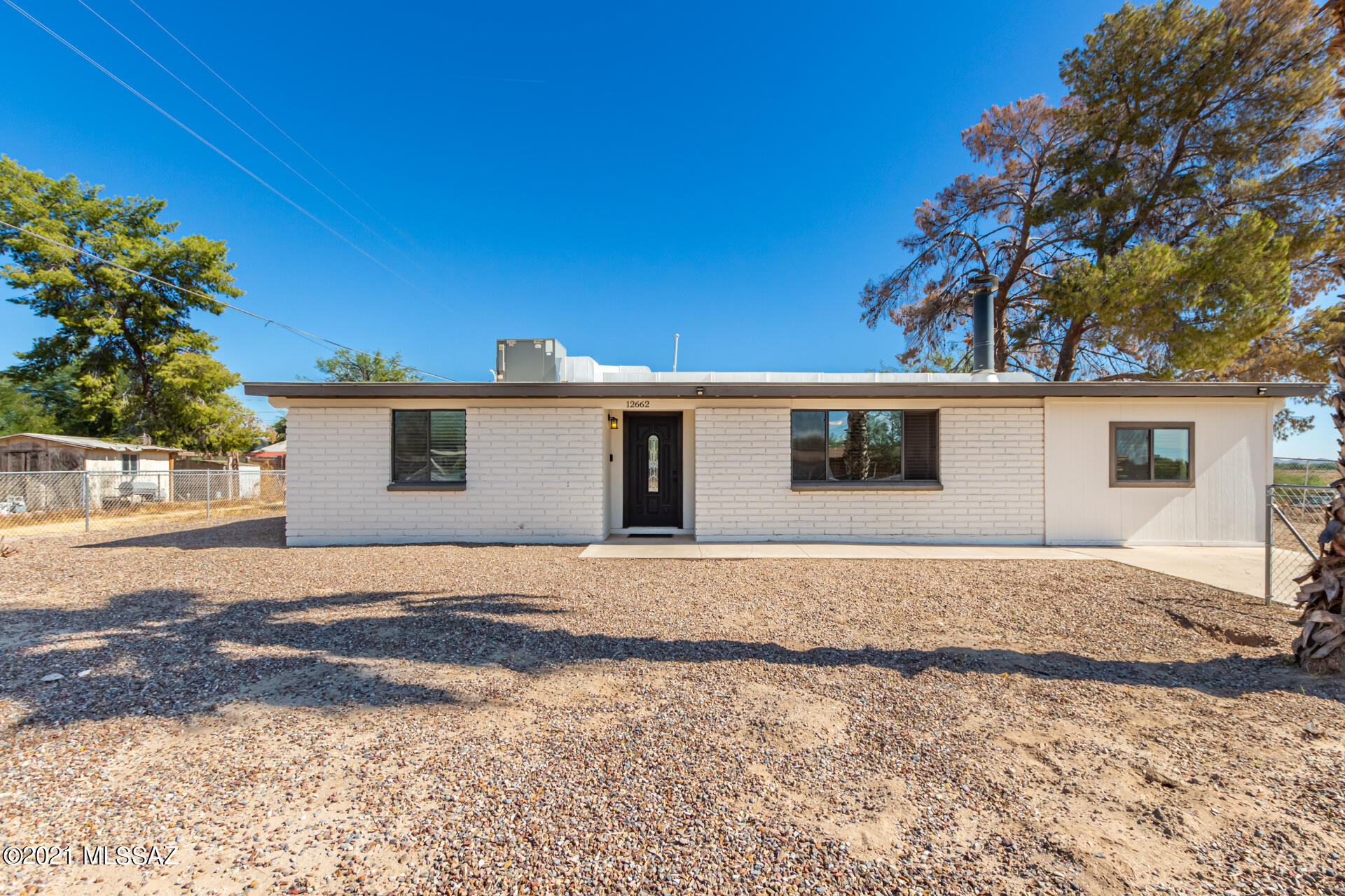 Take a look at this charming home w/3 bedrooms & 2 bathrooms. This home is 1384 sq ft not including the master bedroom and bathroom. Beautifully remodeled w/a trending palette, handsome laminate wood floors t/o, & vaulted ceilings. Cozy living room w/a fireplace for the chilly AZ evenings. Cook your favorite meals in the new eat-in chef's kitchen featuring plenty of white shaker cabinets, SS appliances, back patio access, granite counters, & a breakfast bar. All bedroom have large closets. Sizable main bedroom includes a private bathroom w/granite counters. Expansive backyard w/covered patio & a gazebo is a blank canvas waiting for the new owner's creativity! View today to make it yours!