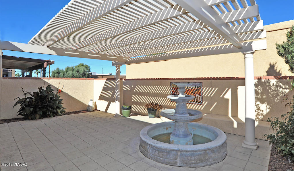 Large 2 Bedroom 2 Bath Townhome in Small Montego Townhome community. Well kept and ready for a new owner. 1200 SQ FT. Open concept floor plan has lots of natural light in all rooms. Wood floors and clerestory windows in living area. Kitchen has corian counters, maple cabinets, hanging pot and wine glass rack and breakfast bar. Master suite has a walk in closet and master bath has dual width vanity. Private back patio has water feature and is fully paved. Rolling Shutters on Patio Door and Master Bedroom Window. Full size washer/dryer, Central A/C & Heat, Wrought Iron Foyer, 2 Car Garage with Built in Storage Cabinets.