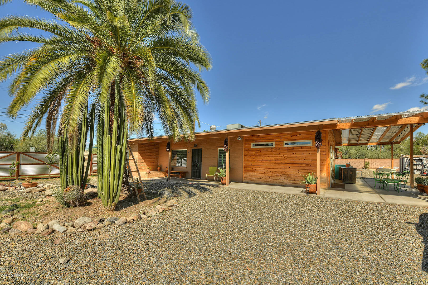 Absolutely stunning, completely renovated burnt adobe oozing with Tucson charm and NO HOA on a huge lot. BRAND NEW guest house with full bath and kitchenette. Brand new ''green'' insulation in both homes - R-19 recycled denim batt energy saving thermal performance and class A fire rated. Brand new plumbing in both main and guest houses. Gorgeous kitchen remodeled floor to ceiling boasts stainless countertops, new Samsung EnergyStar stainless appliances, Mexican tiles, custom butcher block island (stays!), and so much more. New laminate wood floors in both houses. Enjoy views of the Catalinas from the expansive outdoor living spaces. Eat right from your own orchard - lemons, blood oranges, and limes!  R-2 buildable lot! Rare find that you must see to appreciate.  Will NOT disappoint