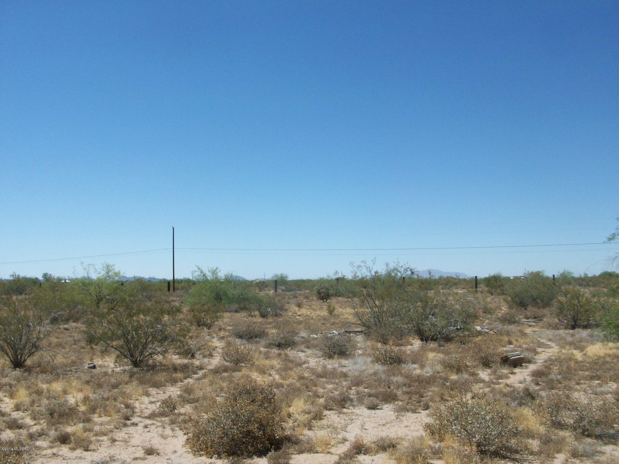 5 acres with well on property (shares with neighbors) - septic and a burned out mobile (needs removal) - storage shed is usable - all structures at east end of property - the remainder is pristine desert land.  Fenced 2 sided and posts for fence on the other 2.  At this price this won't last.