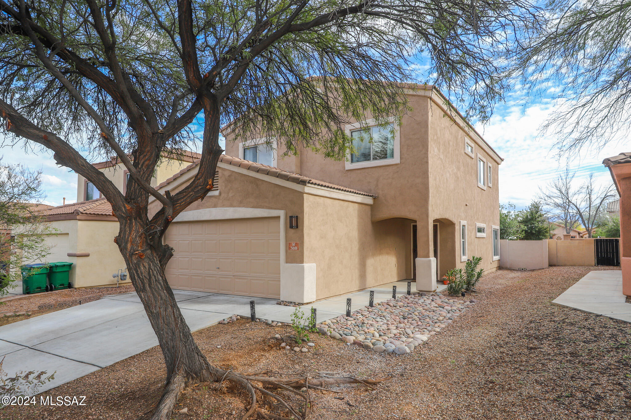 Welcome to your new home nestled within the coveted, award winning, Rancho Sahuarita master planned community. Enjoy the perfect blend of tranquility and convenience, as this gem boasts proximity to parks, playgrounds, soccer/baseball fields, pools and green space, yet offers privacy with no rear neighbors. Immaculate in condition, this residence welcomes you with an open living space, high ceilings, fresh paint, and a versatile downstairs den, ideal for a home gym, playroom, or office. The upgraded laundry room features charming wallpaper, a crystal chandelier, and custom shelving- Along with a stunning, upgraded powder room. The kitchen is a vision of elegance with a soft, neutral color palette, granite countertops, and stainless steel appliances. A Picture-perfect window above the sink showcases the fully landscaped backyard. Retreat to the second floor where all bedrooms are thoughtfully arranged, including a spacious primary suite with two walk-in closets. Outdoors, a Flagstone patio, fully covered for year-round enjoyment, complements the mature, lush landscaping, providing a serene escape with no rear neighbors. Don't miss out on this rare find in an excellent price point. Welcome home to Rancho Sahuarita Living!
