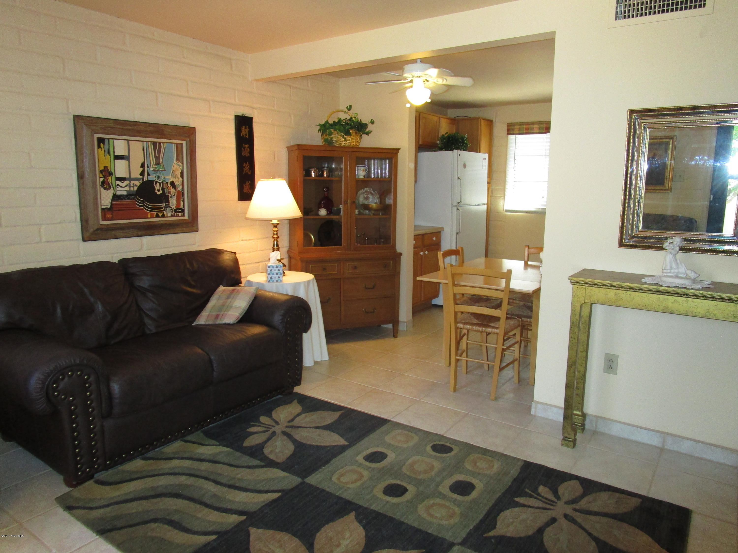 What a sweet place! Joyful paint colors and trim, updated with tile flooring, newer kitchen counter tops and cabinets, bath updated with shower, vanity and toilet. Set back from the parking, there is a large tree in the front courtyard, grass beyond in the common area; the courtyard also has a gate. Tastefully furnished (except master bedroom - you will have to get your own) and all the kitchen items, linens so all you have to do is enjoy!