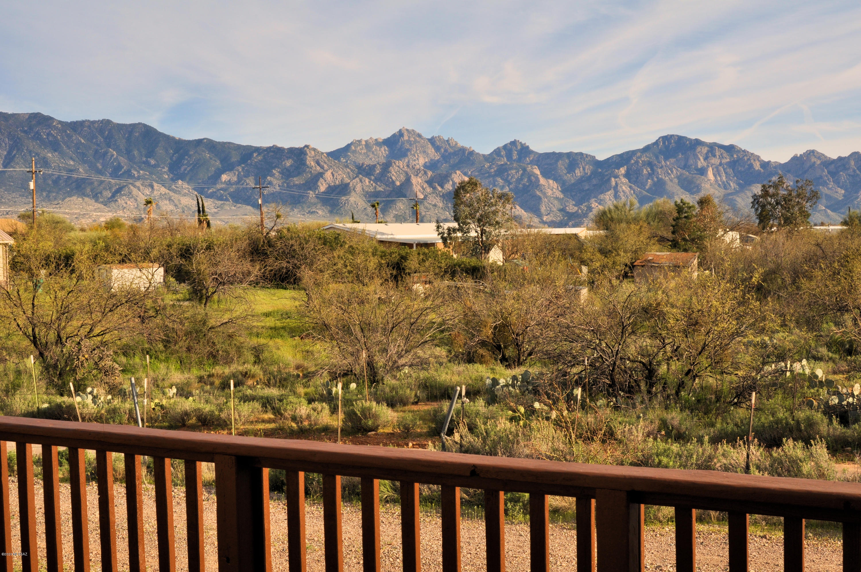 PANORAMIC MOUNTAIN VISTA on the sweetest acre in Catalina! Enjoy a flat and elevated property with access by paved roads! Quality Cavco home with 2 decks made to last with pressure-treated lumber! Secure skirting set atop a ribbon concrete footer. Wide open floor plan with high ceilings in the great room. Nearly every window offers fabulous mountain views! Formal dining area w/built in china hutch! Country Oak Kitchen fully equipped with appliances! Breakfast nook! Full laundry rm with washer/dryer included. Large Owner's BR w/ walk in closet! The bath has a soaking tub with views to rival the finest resort! Separate shower and long vanity! Bedrooms 2 & 3 also have walk ins. No HOA, No CC&Rs! This is HORSE PROPERTY! Garden to your heart's content then, RELAX w/ a cool drink on the deck!