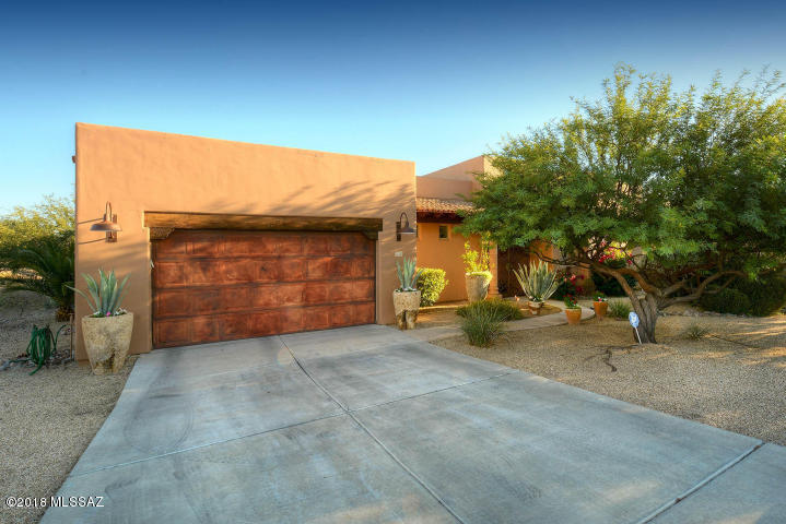 Beautiful custom Hacienda model in desirable Santiago II. Exquisite style & modern regional charm grace this lovely 3BR, 3.5Ba home. From the street to the rear wall, the attentive use of natural stone, wood (beams), finished cement, ceramic tile, hardwoods (interior flooring) and sophisticated lighting invite you home. The beamed living room (w/Cantera stone gas fireplace & large Anderson doors) adjoins both captivating front and rear patios (w/fountain, gas fire pit & SS grill). The spacious kitchen, w/SS appliances, hood, wall mounted ovens, natural gas cook top, granite tops & island, overlook the adjacent dining area. Spacious bedrooms & baths. Storage & wall space abound. Clean, simple, low maintenance landscape. Beauty and refinement inside & out! Available fully furnished.
