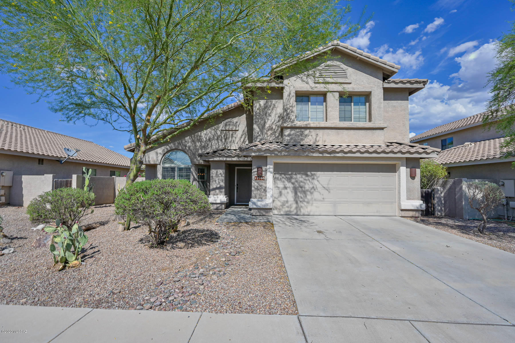 You will love the great privacy and mountain views from this Rancho Vistoso home!  Updated throughout, this very popular floorplan has formal and casual living and dining spaces.  Gourmet kitchen features white cabinetry, stainless steel appliances, large pantry and slab granite countertops.   Huge family room with gorgeous new custom fireplace surround. New wood look tile, custom wood work throughout, new lighting & ceiling fans throughout, all baths have been remodeled to perfection,  new carpet upstairs only, custom barn door at Owner's Bath, completely repainted interior.   Owner's Suite is a peaceful sanctuary with a spa-like bath.  Back yard features extended covered patio, extensive flagstone and pavers, greenbelt behind with no neighbor, Catalina Mountain views and afternoon shade.