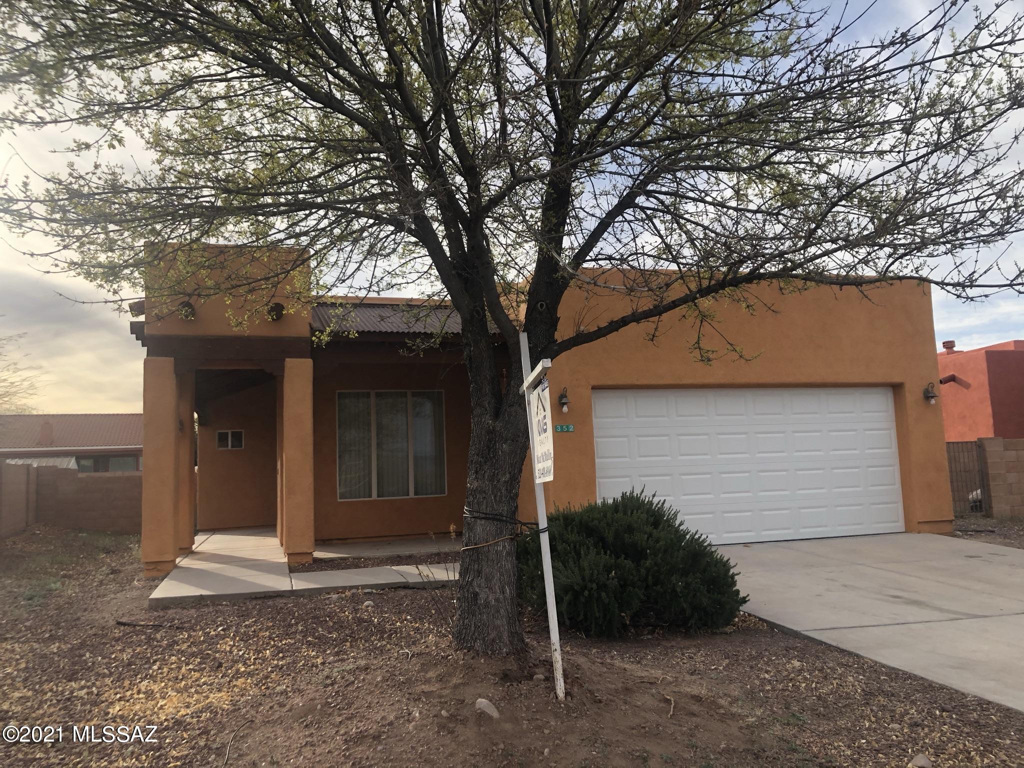 Centrally located home in a well established neighborhood of Rio Rico. This 3 bedroom/2 1/2 bath home is a split floor plan with many extras. The spacious kitchen opens to the living room/dining area. The high ceilings and large windows give it the open feeling. The tile floors, beehive fireplace, ceiling fans, walk-in closet are some of the many extras. The rear yard is walled in for your privacy. Easily accessible from the freeway, close to shopping and very easy to show! Bring us your offers....