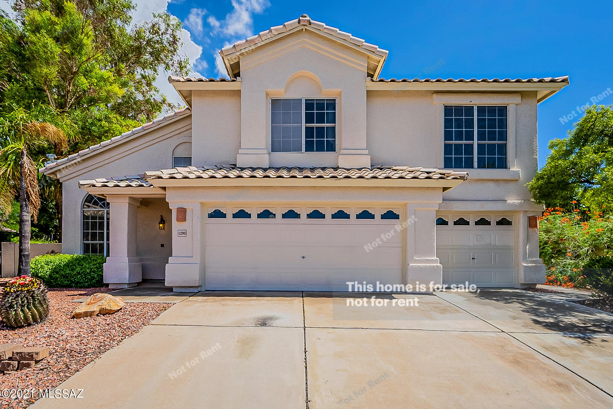 This Tucson two-story home offers a patio, and a three-car garage.