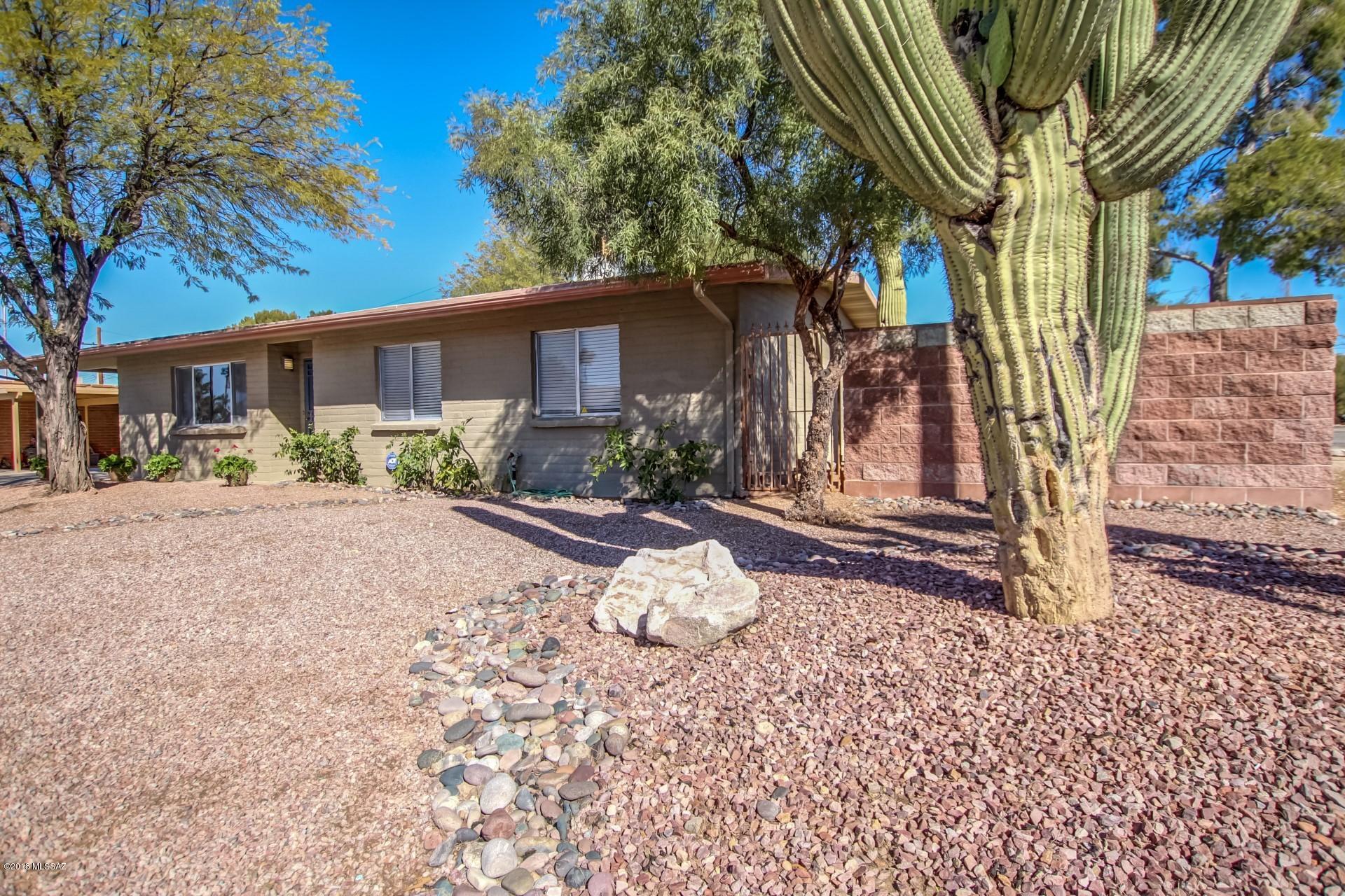 Charming 3 bed home in a great Tucson location! Move in ready with an open floor plan that features tile & laminate flooring, plush carpeting, and custom paint tones in all the right places. Upgraded kitchen boasts stainless steel appliances, and ample cabinet and counter space. Large Arizona room overlooks the generous backyard. Spacious master bedroom has an adjoining bath with a tile surround shower. Large mature trees and easy care landscape in front and back! This home is ready for your touches!