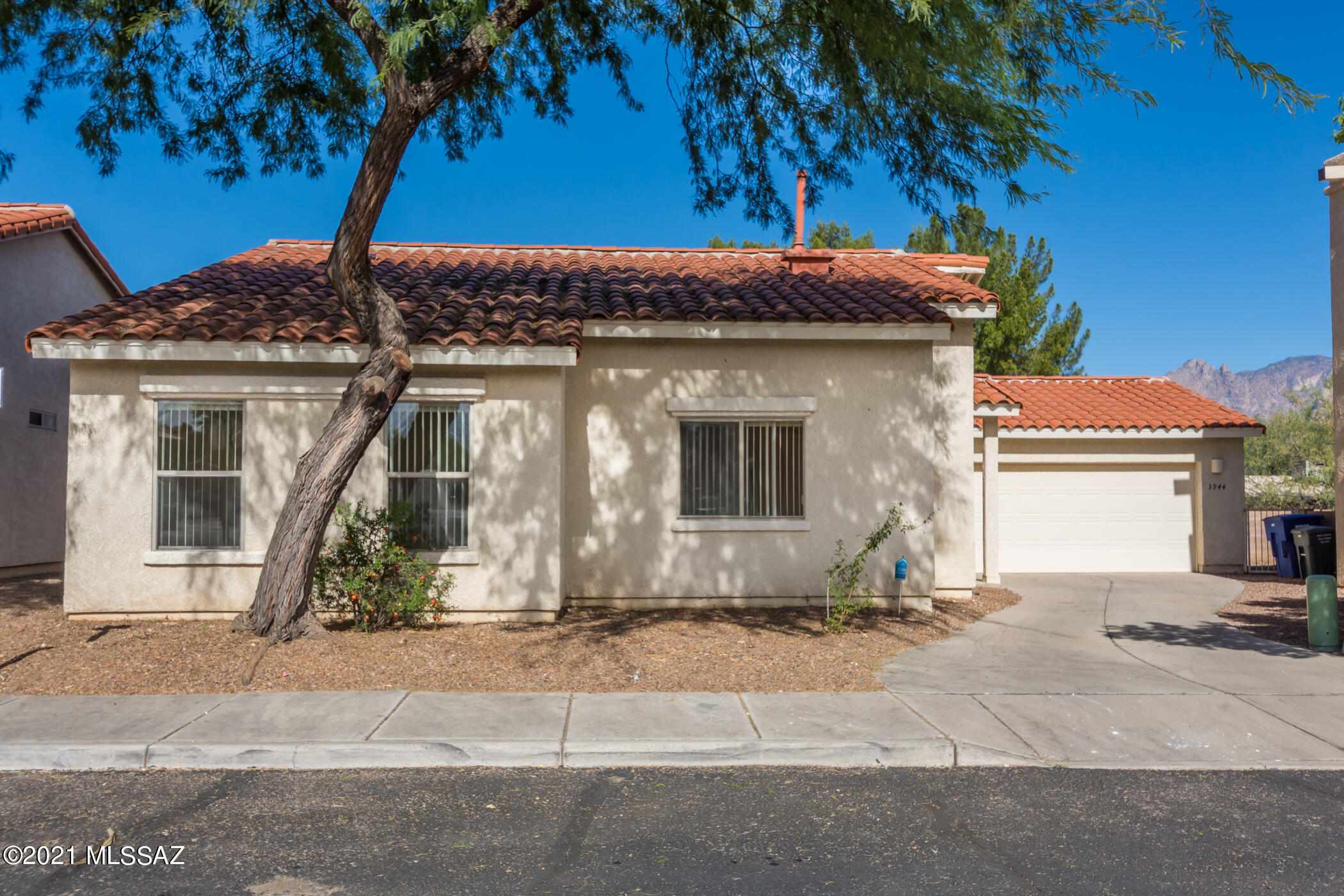 This is a beautiful tiled roof single story home in a small 12 home gated community. It sits on a cul de sac and is private but near amenities. The home features brand new carpet, new microwave and a newer washer and dryer. The kitchen is open and ready. It is spacious and light and has easy care yards. It has been well cared for and it is neat and clean. Come and see this charming home.  One owner is a licensed realtor in the state of Arizona.