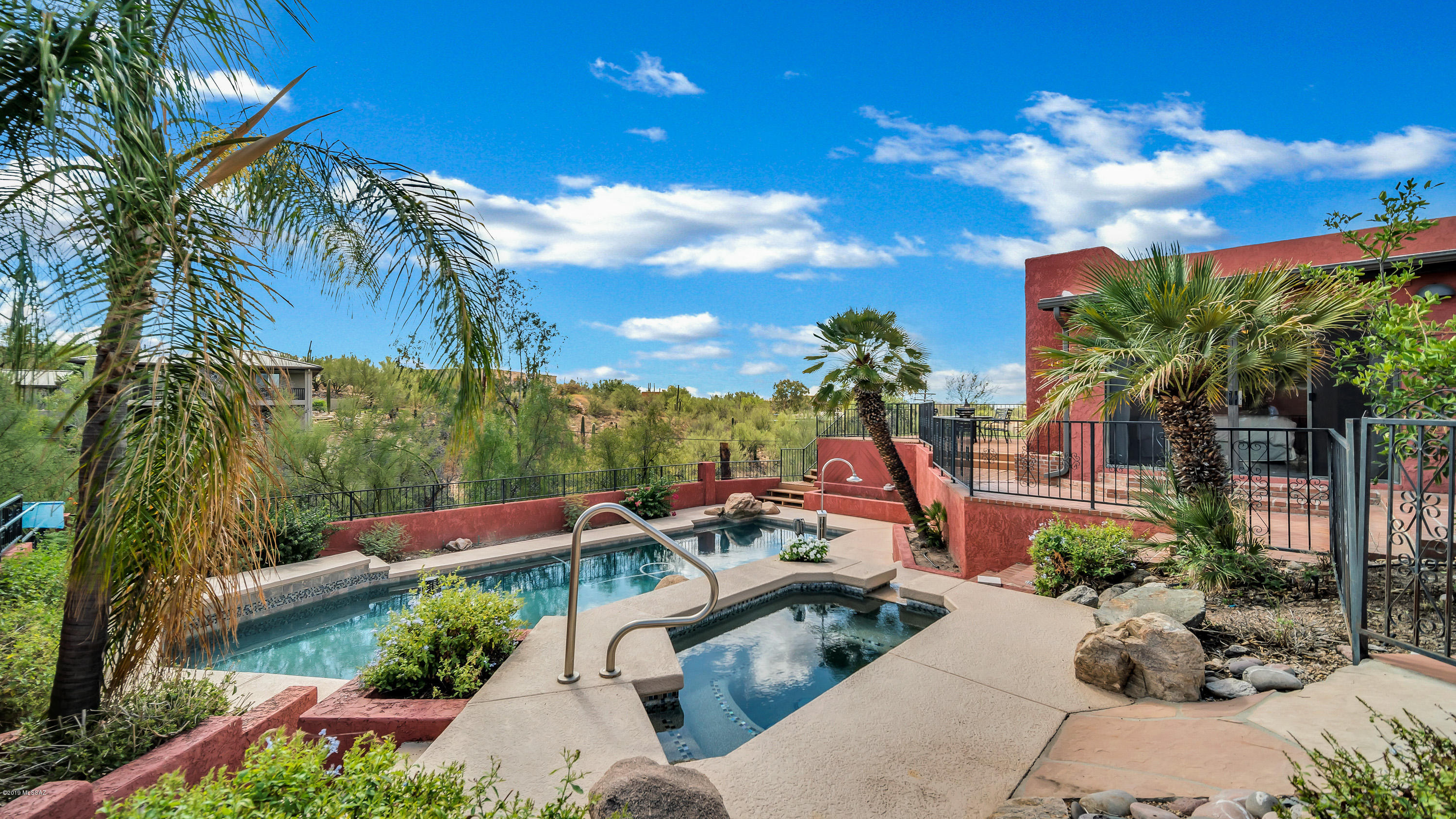 Enjoy Foothills luxury in this home w/ the privacy of a cul-de-sac, and the benefit of both stunning Tucson cityscape & Catalina Mountain views. Located w/i Catalina Foothills District 16, this 4bed 3bath home boasts large living areas w/ two master bedrooms each w/ their own ensuite bath, a casita/in-law suite, breakfast nook w/ barn doors, living room, dining room, and family room w/ beamed ceilings, fresh interior paint, contemporary lighting, 7 skylights for ample natural lighting,  laundry room w/ sink, walk-in pantry, two wood burning fireplaces, outside private access to a bathroom through a cute blue wooden gate, a front courtyard, 2 patio decks, a massive resort style pool w/ a depth of 10 feet & above ground spa, and a massive rec room/studio that can be converted into a garage.