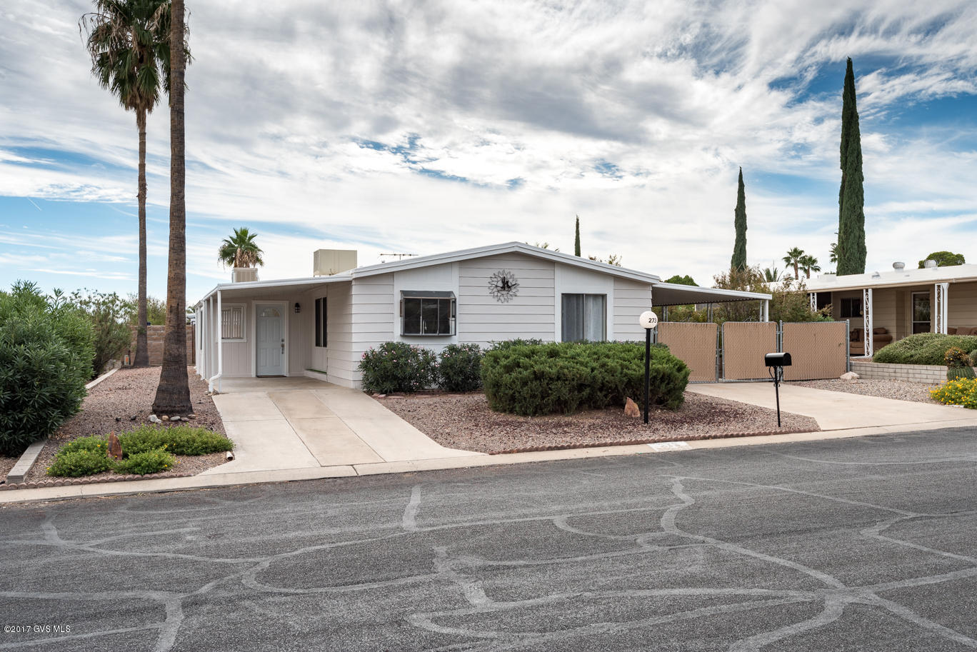 This home has just been completely remodeled & upgraded throughout, with dedication to quality, comfort & safety. The open & bright, completely new kitchen, dining room & great room are beautiful, functional & very spacious. Two Beautiful new bathrooms with walk in tile showers.. could be a his & hers! The upgrades include new cabinets & counters, flooring, lighting, window treatments, etc. Even the water heater is new! Both bedrooms are spacious & have walk in closets. Home is freshly painted inside & out. One of two carports is gated & has a shop area & storage room as well as a section of fenced yard which offers safety for pets. The welcoming built on Bonus room with laundry center will also make an excellent craft room, office, sunroom or game room. Recreation center very close by  & offers heated salt water pool, hot tub, exercise room, library, pool tables, horseshoe courts, shuffleboard, ceramics, crafts, card games, bingo, weekly trash pick pu & rad maintenance... all included in the HOA fee of $55.00 monthly.