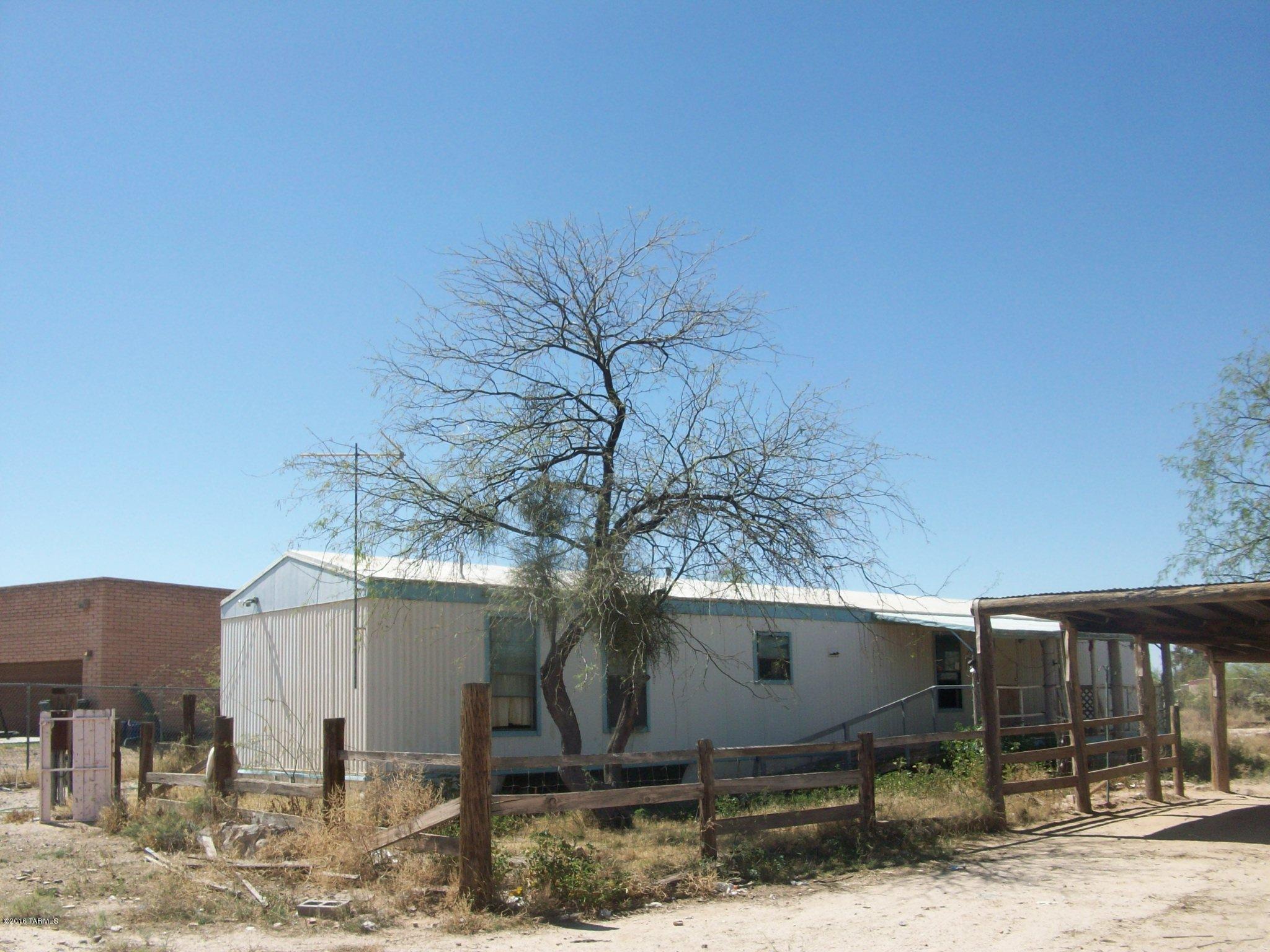 Fix up manufactured home with additions - fully gated and fenced acre - The ''bones'' are here to fix this and make it your first home.  Undercover parking for three, propane tank for cooking and heat - check it out.