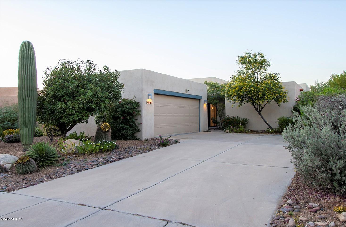 Beautiful Santa Fe style home of Integra masonry block construction with stucco finish. Mountain views over private 12 acre fenced desert park with trails owned by HOA; 2 bedrooms plus den which could be 3rd bedroom. Easy-care tile throughout. Interior of home and garage freshly painted.  Beautifully landscaped yard with irrigation system. One owner, well-maintained home designed to minimize allergens. Quiet community of 39 homes, amenities include lap pool, spa, playground, and the 12 acre park. Wide streets and sidewalks. Great location, easy access to Pima College; Public, Charter & Private schools; YMCA, Churches, Hospitals, Public Library, Tohono Chul Park, Golf, The Loop, movie theaters, dining, shopping & more. This is a beautiful home in a great community!