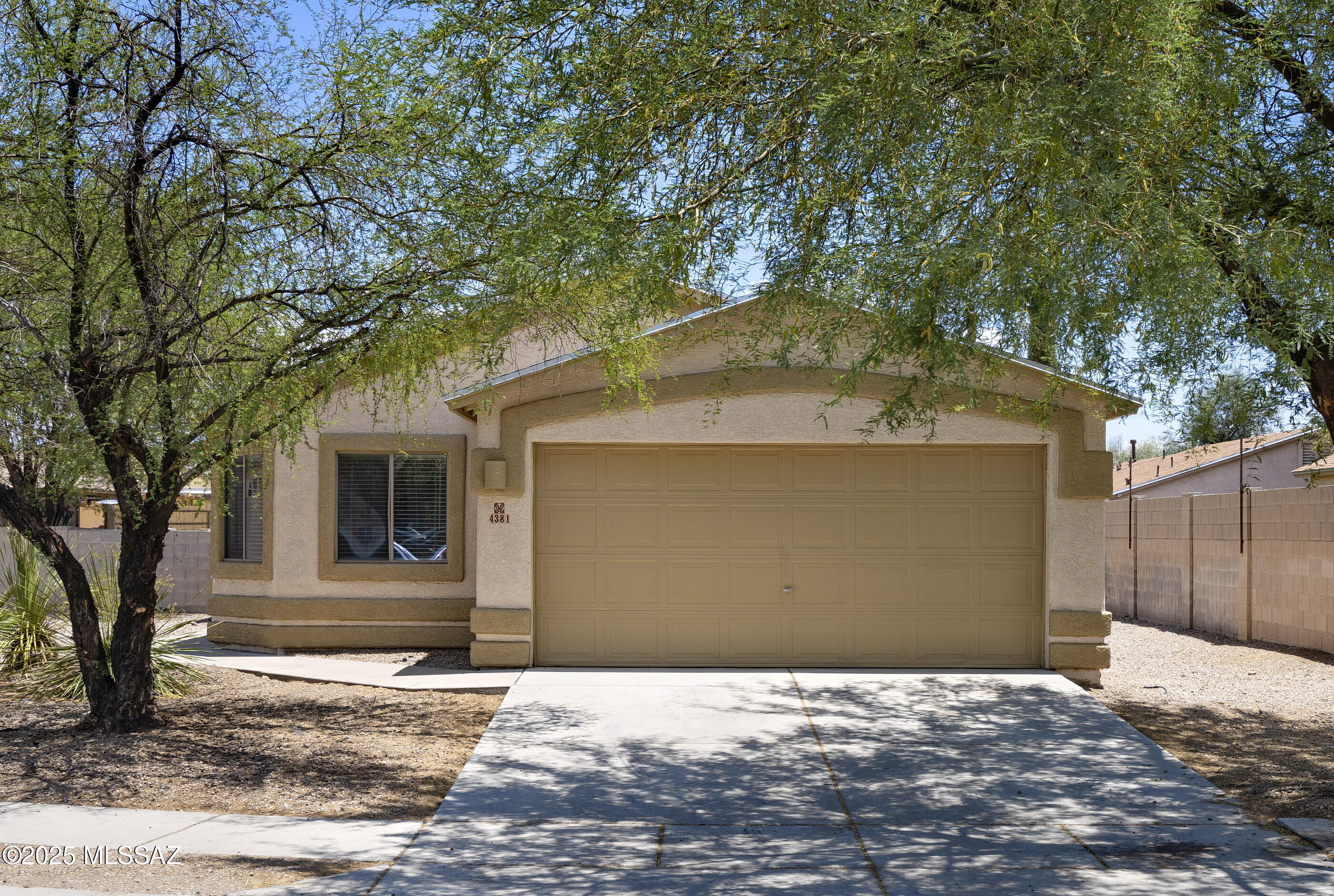 Corporate owned—offers responded to within 72 hours, Monday-Friday only, thank you! This 1538 square foot, 4 bedroom, 2 bath home has a split bedroom floorplan with flexibility. The living space with soaring ceilings has access to the private backyard and is open to the kitchen. High ceilings continue into the kitchen, which has an adjacent dining area and offers a pantry closet and all appliances, including a gas stove. One guest bedroom is off the living space and could also be used as a home office, playroom or den. Overlooking the backyard, the primary bedroom has a private bath with walk-in shower, separate oval tub, dual vanities and a walk-in closet. Two additional bedrooms are serviced by a full hall bath. A convenient laundry room and a two car garage complete this home, while outdoors the fully fenced backyard area has lots of possibilities. Your new home is located just 10 minutes from  shopping and dining, including Target, Home Depot, Food City, Olive Garden and much more at Tucson Spectrum Mall.